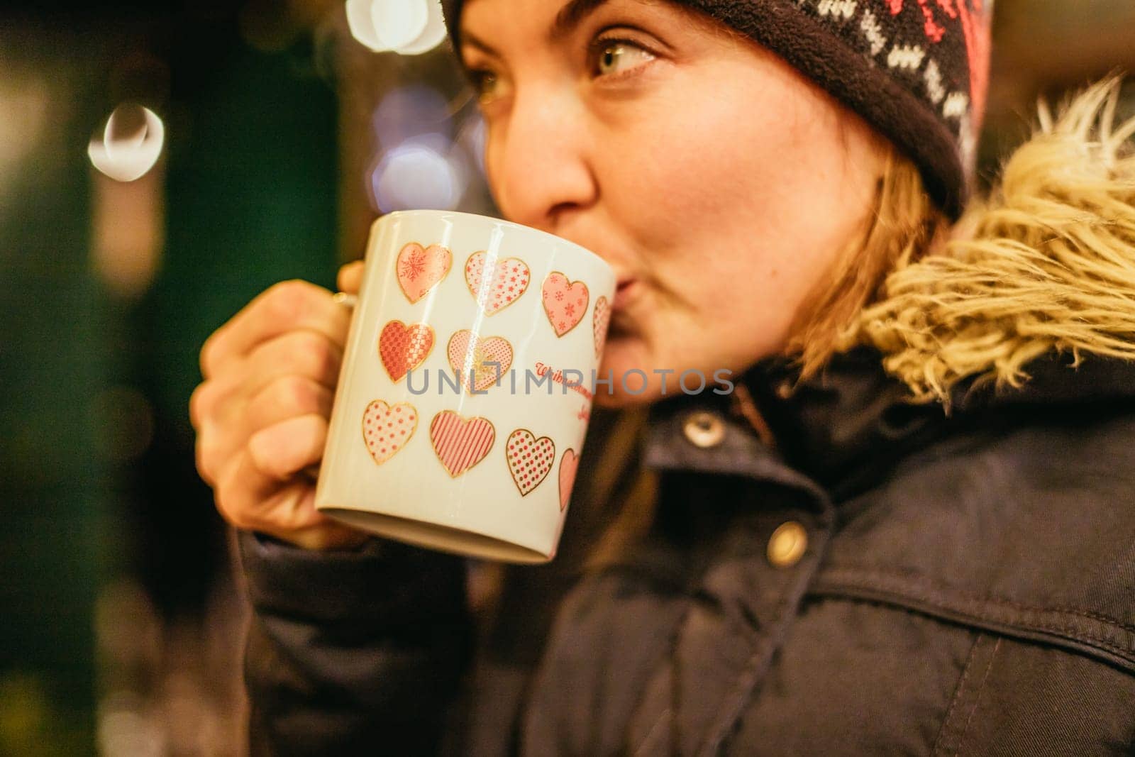 Girl is drinking mulled wine on the Christmas market, fun