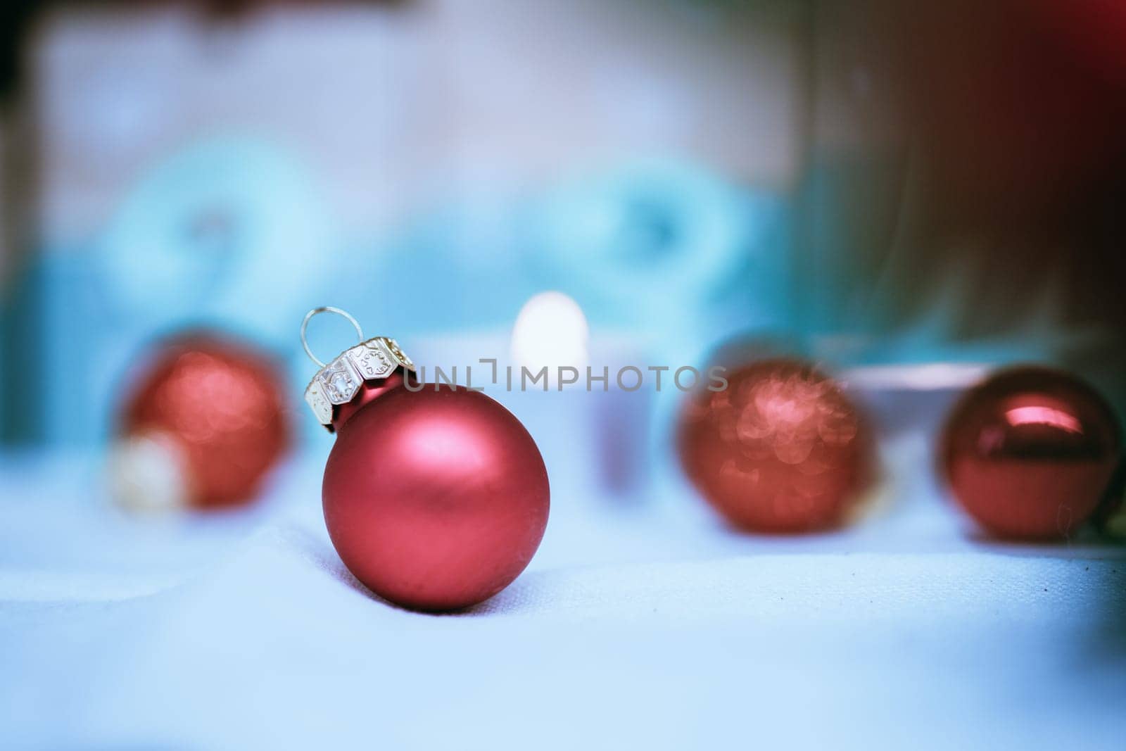 Christmas decoration: Close up of red Christmas baubles, advent calendar in the blurry background