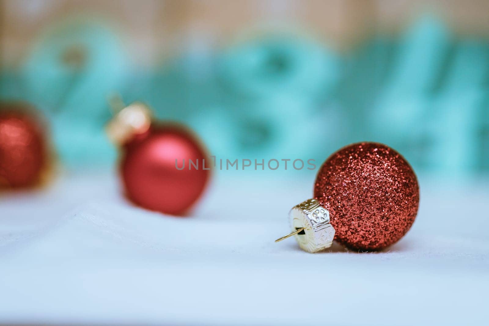 Christmas decoration: Close up of red Christmas baubles, advent calendar in the blurry background