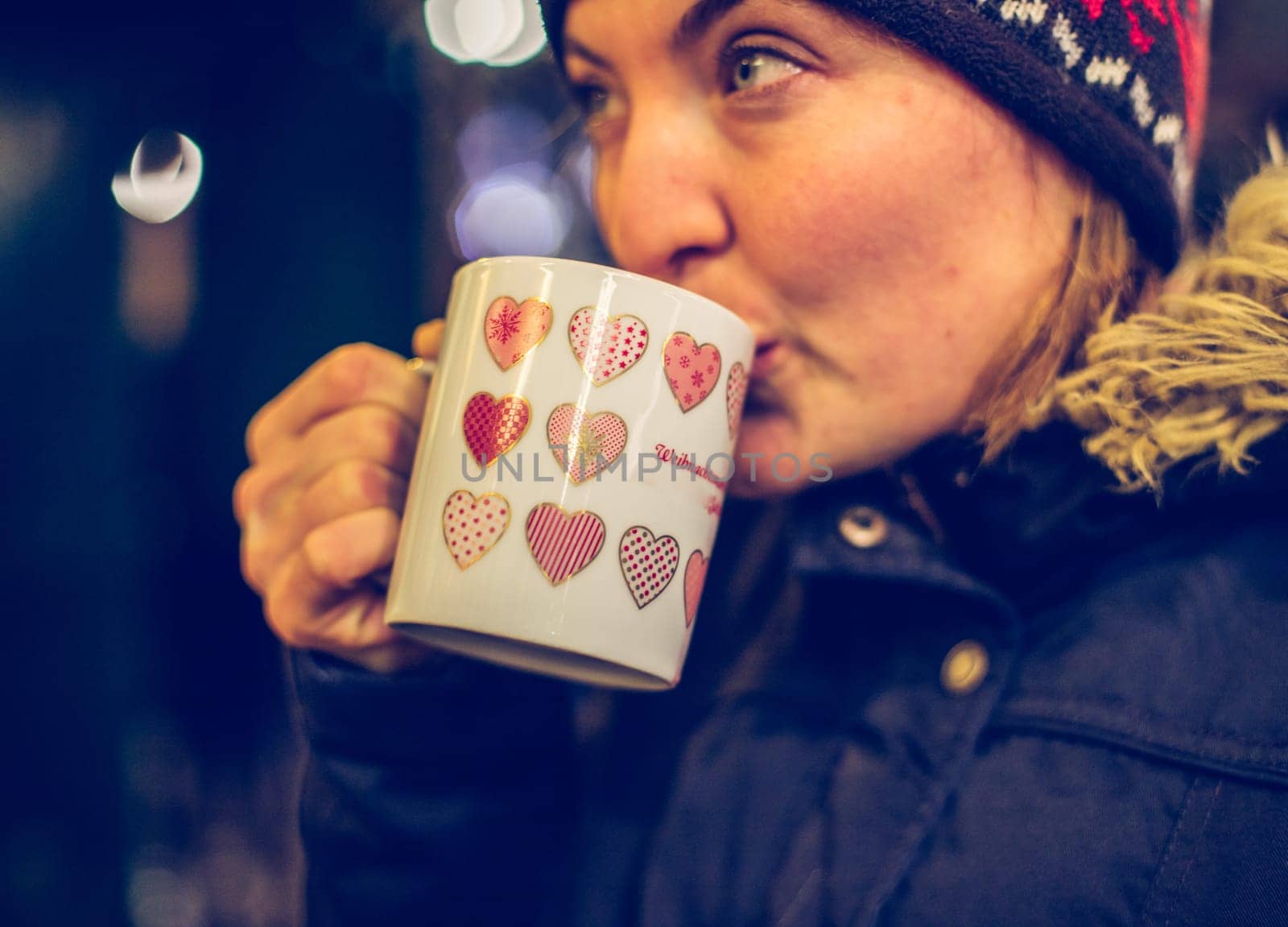 Girl is drinking mulled wine on the Christmas market, fun