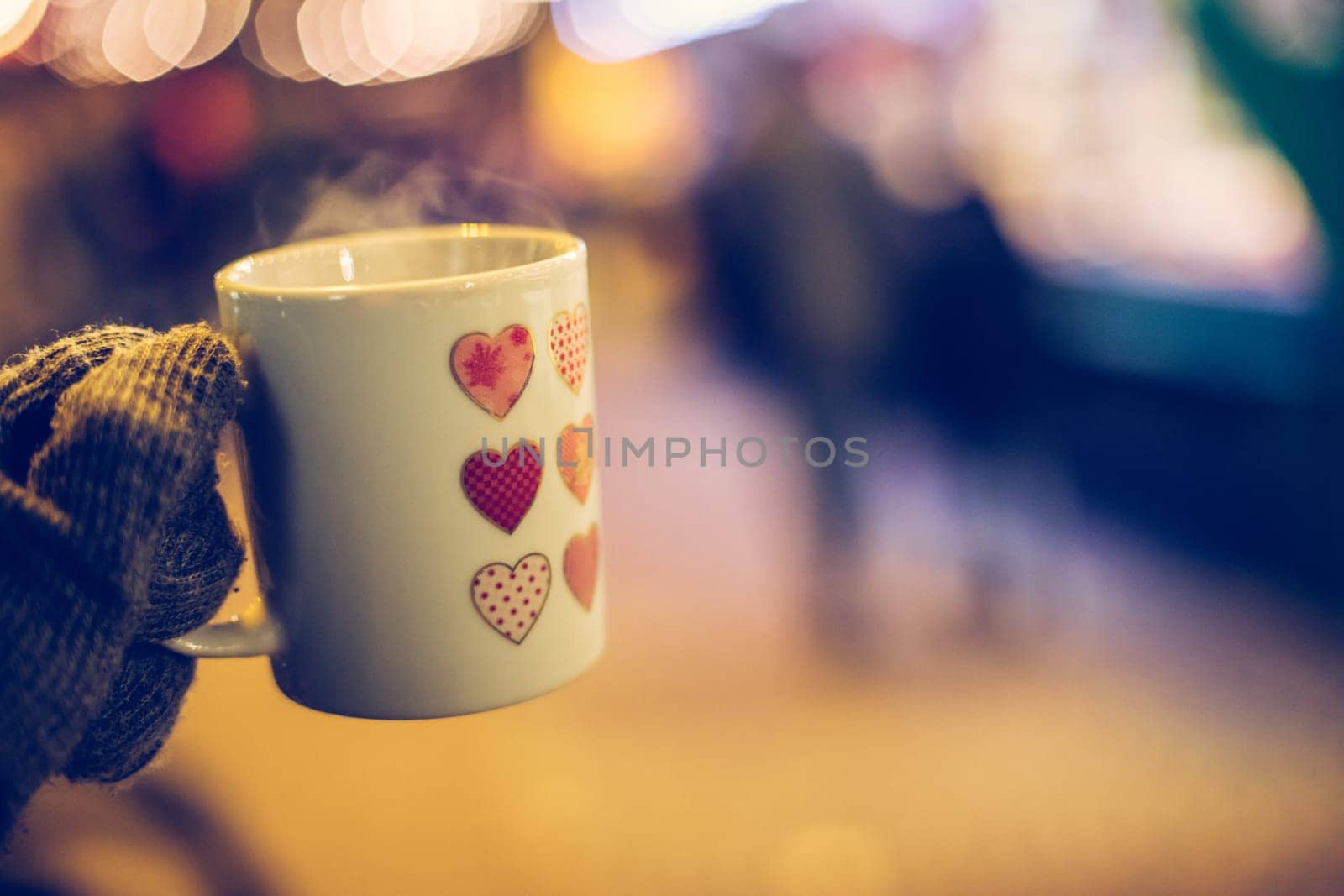 Enjoying Christmas time on the Christmas market. Close up of a cup of mulled wine.