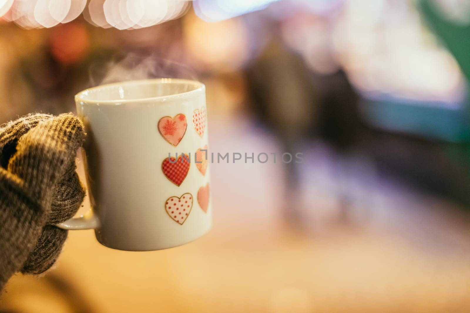 Enjoying Christmas time on the Christmas market. Close up of a cup of mulled wine.