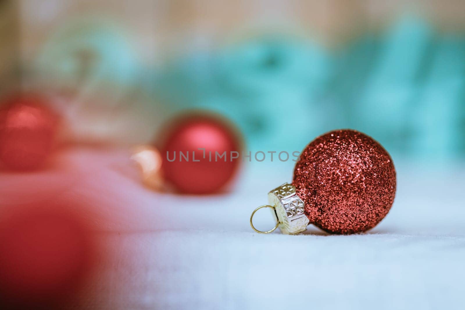 Christmas decoration: Close up of red Christmas baubles, advent calendar in the blurry background