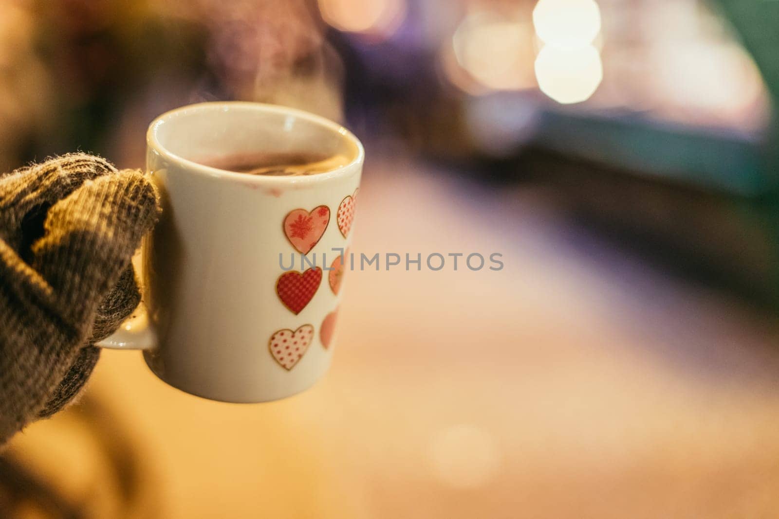 Enjoying Christmas time on the Christmas market. Close up of a cup of mulled wine.