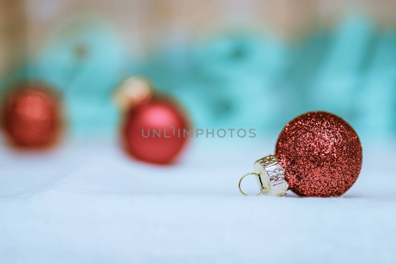 Christmas decoration: Close up of red Christmas baubles, advent calendar in the blurry background