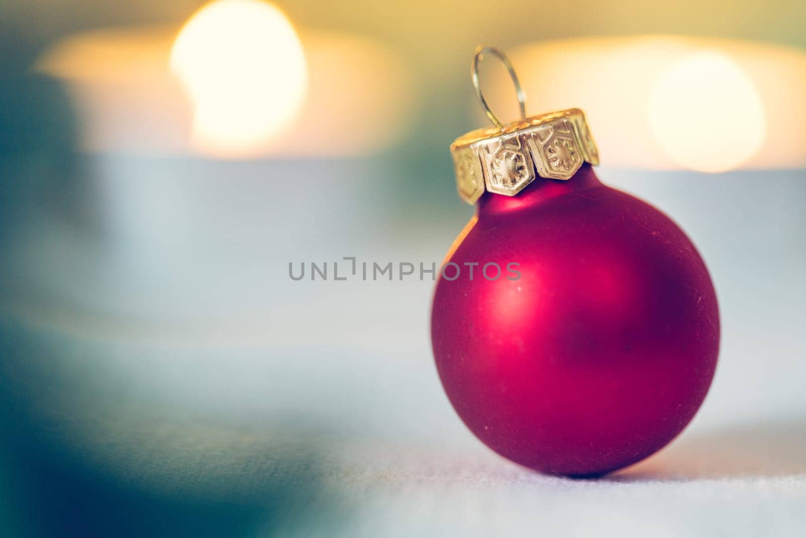 Christmas decoration: Close up of red Christmas baubles, advent calendar in the blurry background