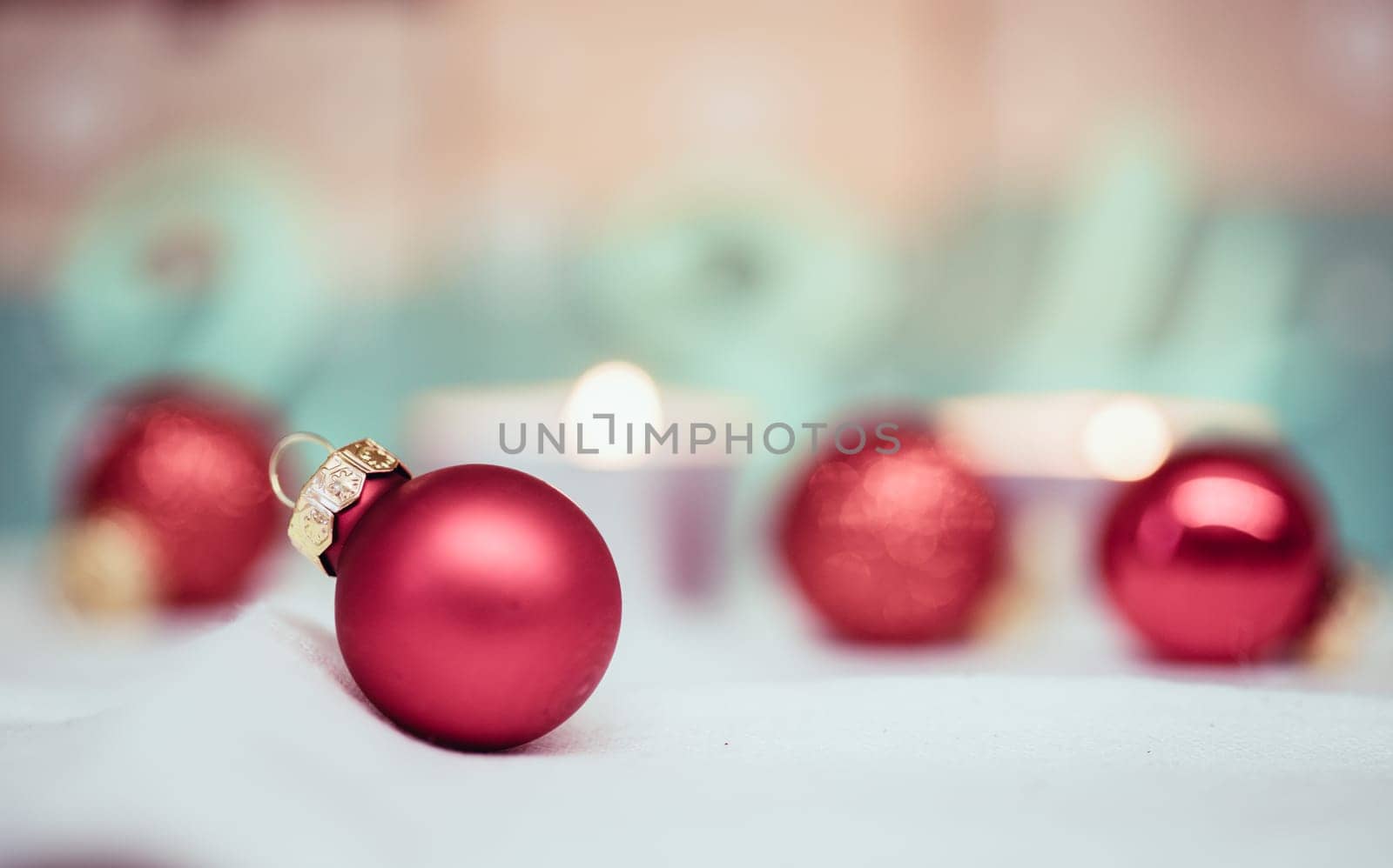 Christmas decoration: Close up of red Christmas baubles, advent calendar in the blurry background
