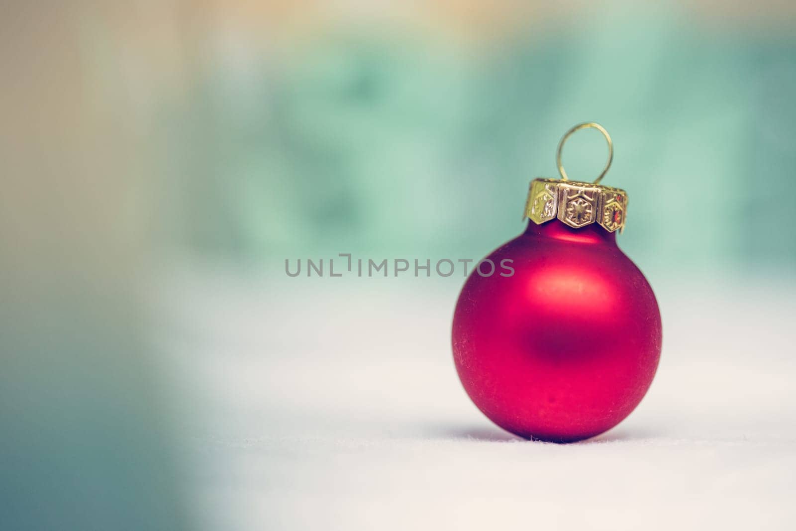 Christmas decoration: Close up of red Christmas baubles, advent calendar in the blurry background