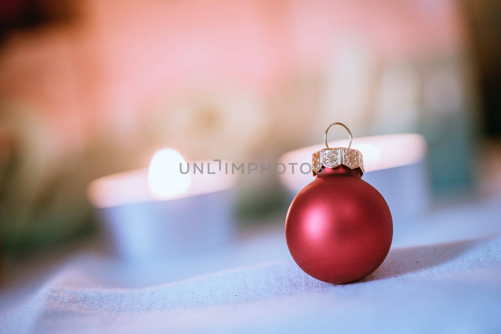 Christmas decoration: Close up of red Christmas baubles, advent calendar in the blurry background