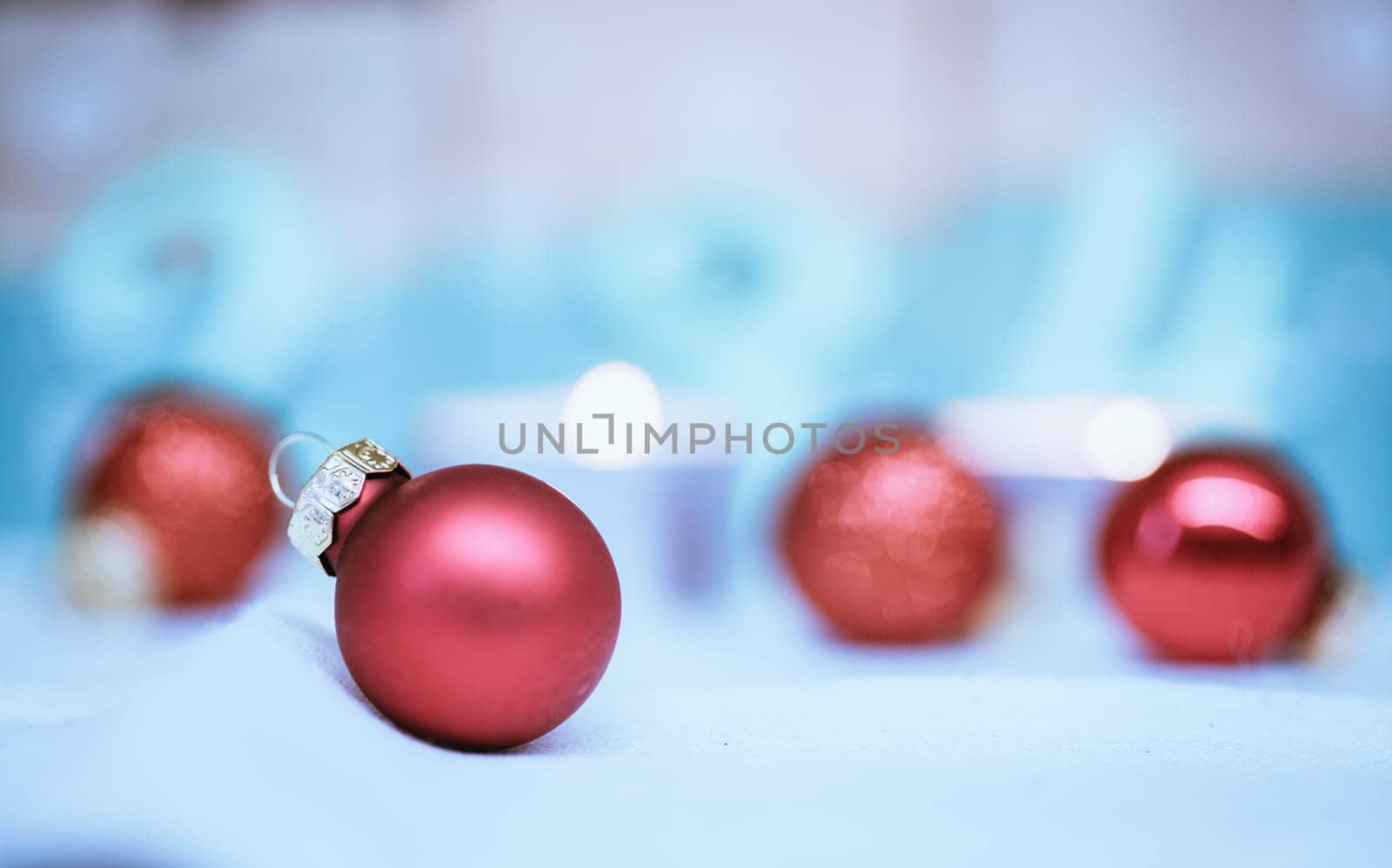 Christmas decoration: Close up of red Christmas baubles, advent calendar in the blurry background