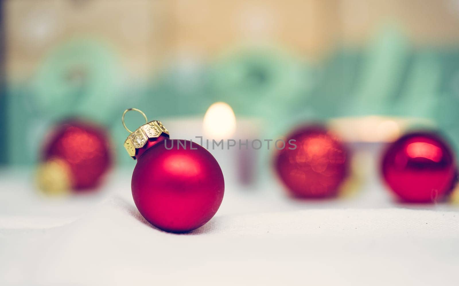 Christmas decoration: Close up of red Christmas baubles, advent calendar in the blurry background