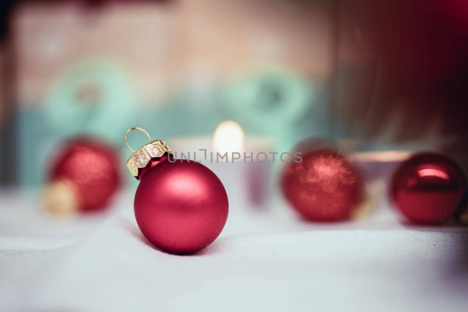Christmas decoration: Close up of red Christmas baubles, advent calendar in the blurry background