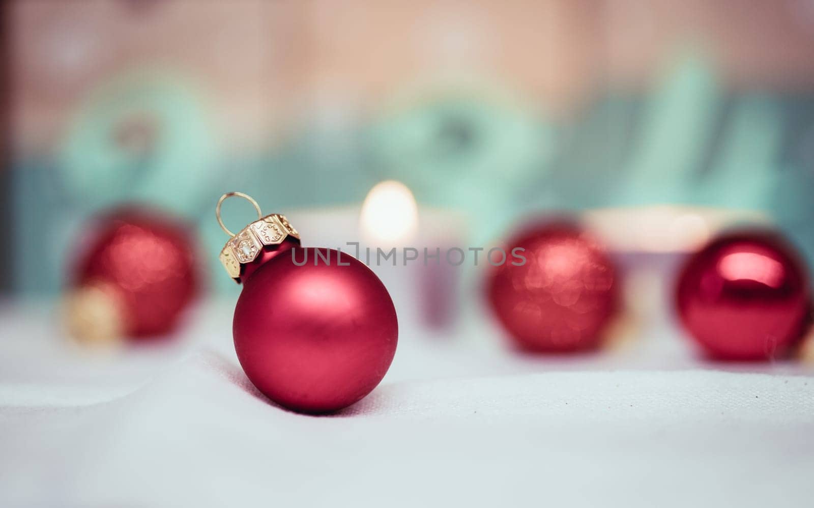 Christmas decoration: Close up of red Christmas baubles, advent calendar in the blurry background
