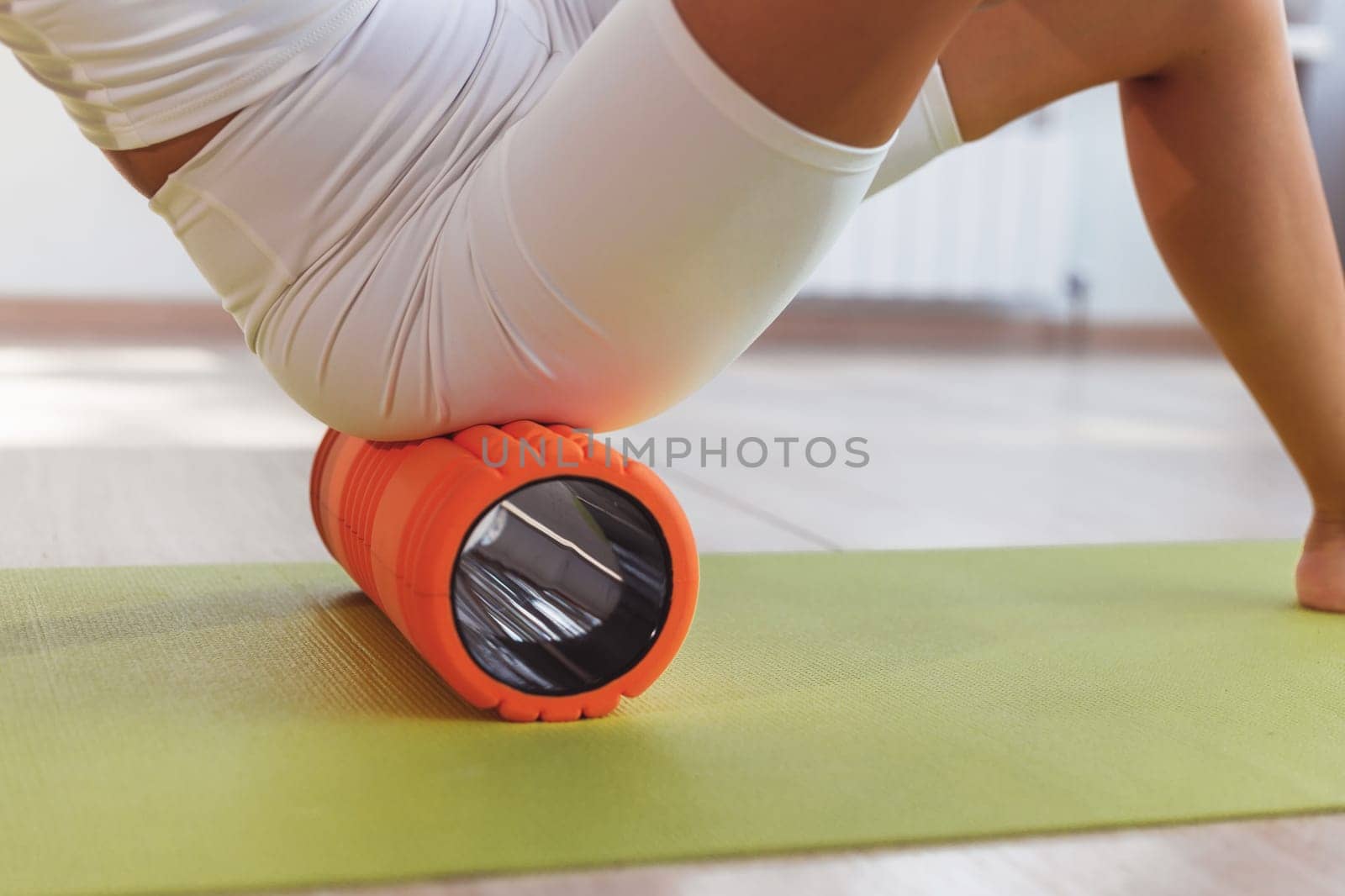 Woman doing exercises foam roller