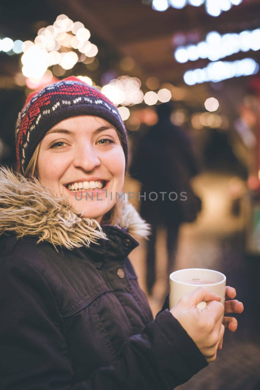 Girl is drinking mulled wine on the Christmas market, fun