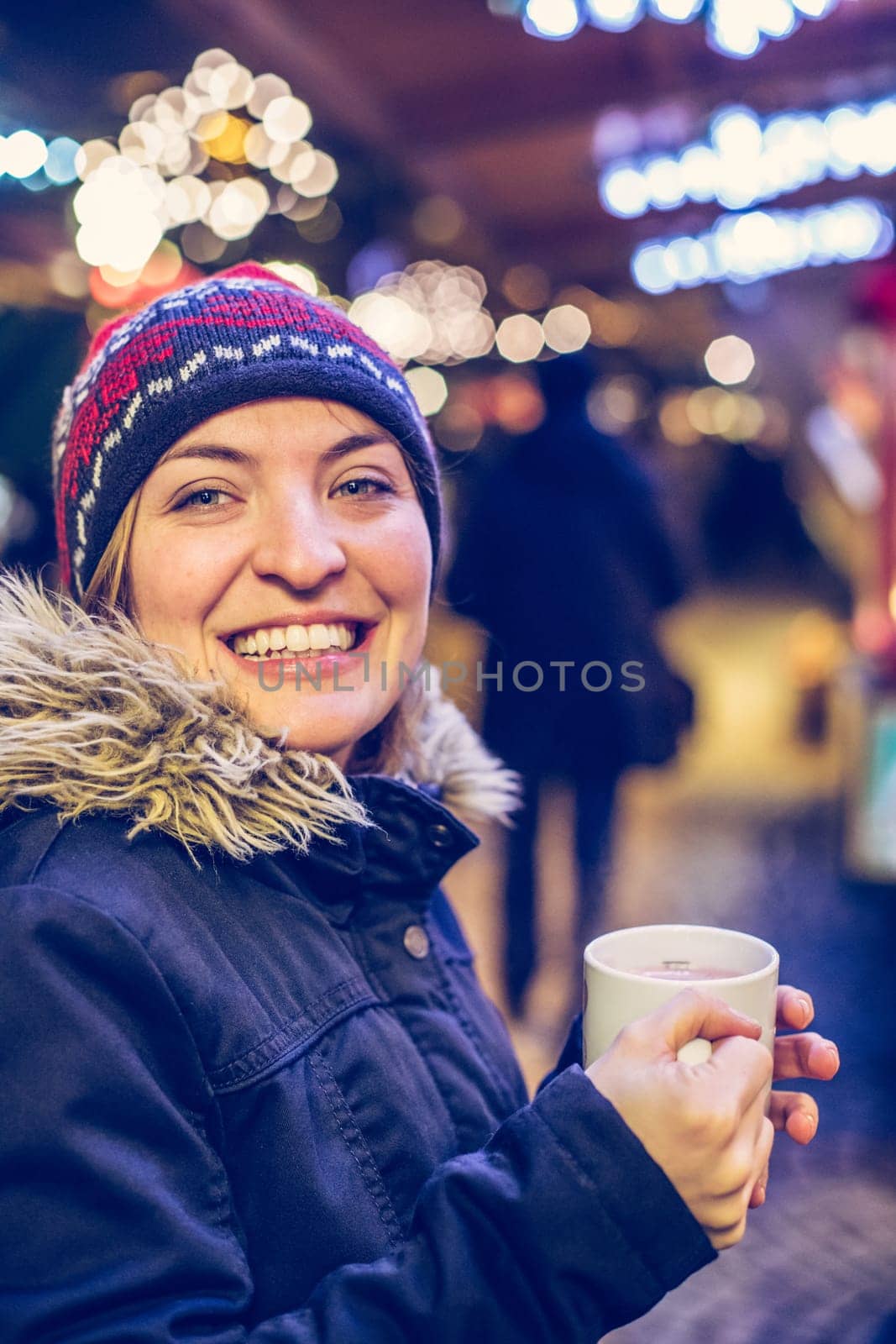 Girl is drinking mulled wine on the Christmas market, fun