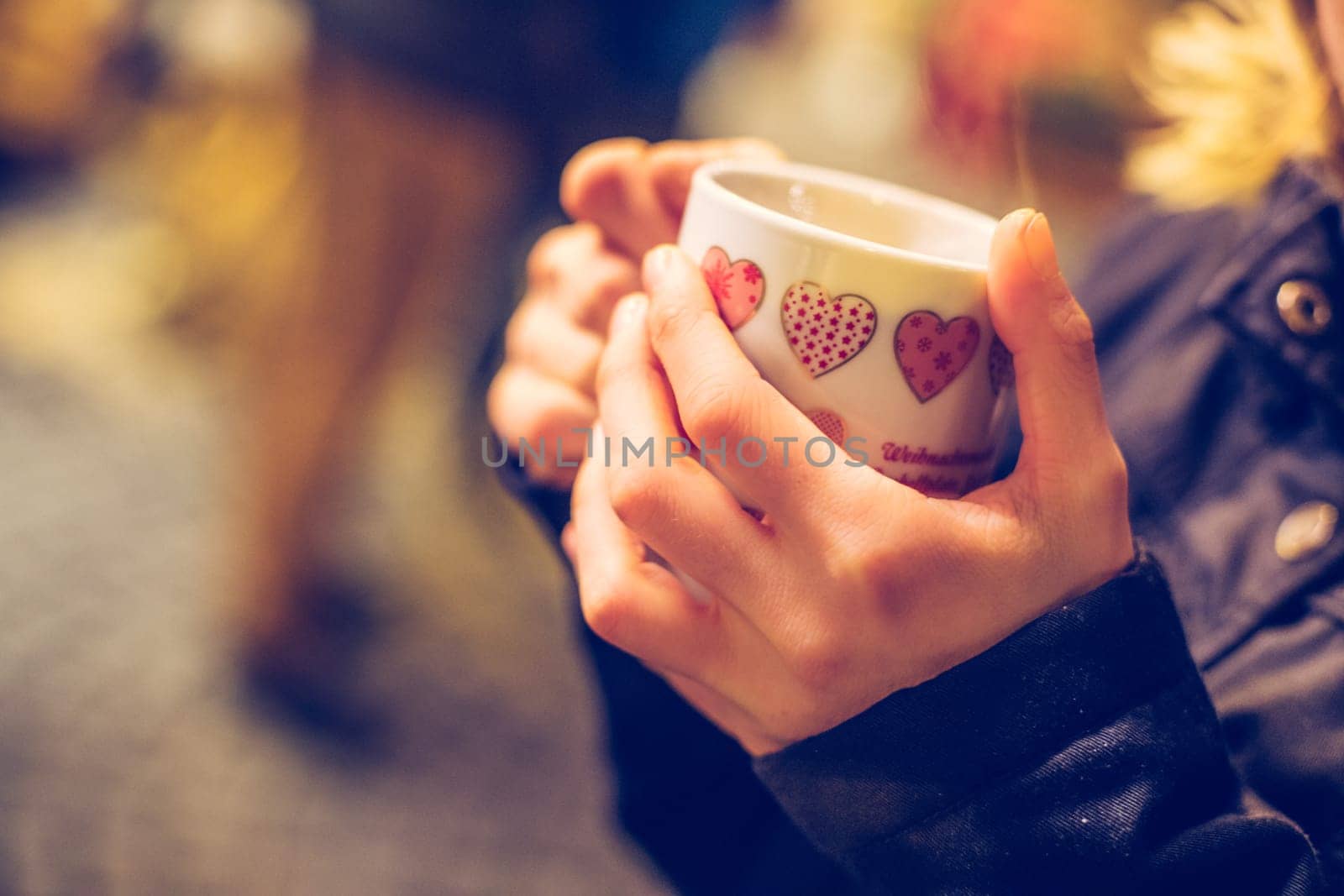 Enjoying Christmas time on the Christmas market. Close up of a cup of mulled wine.
