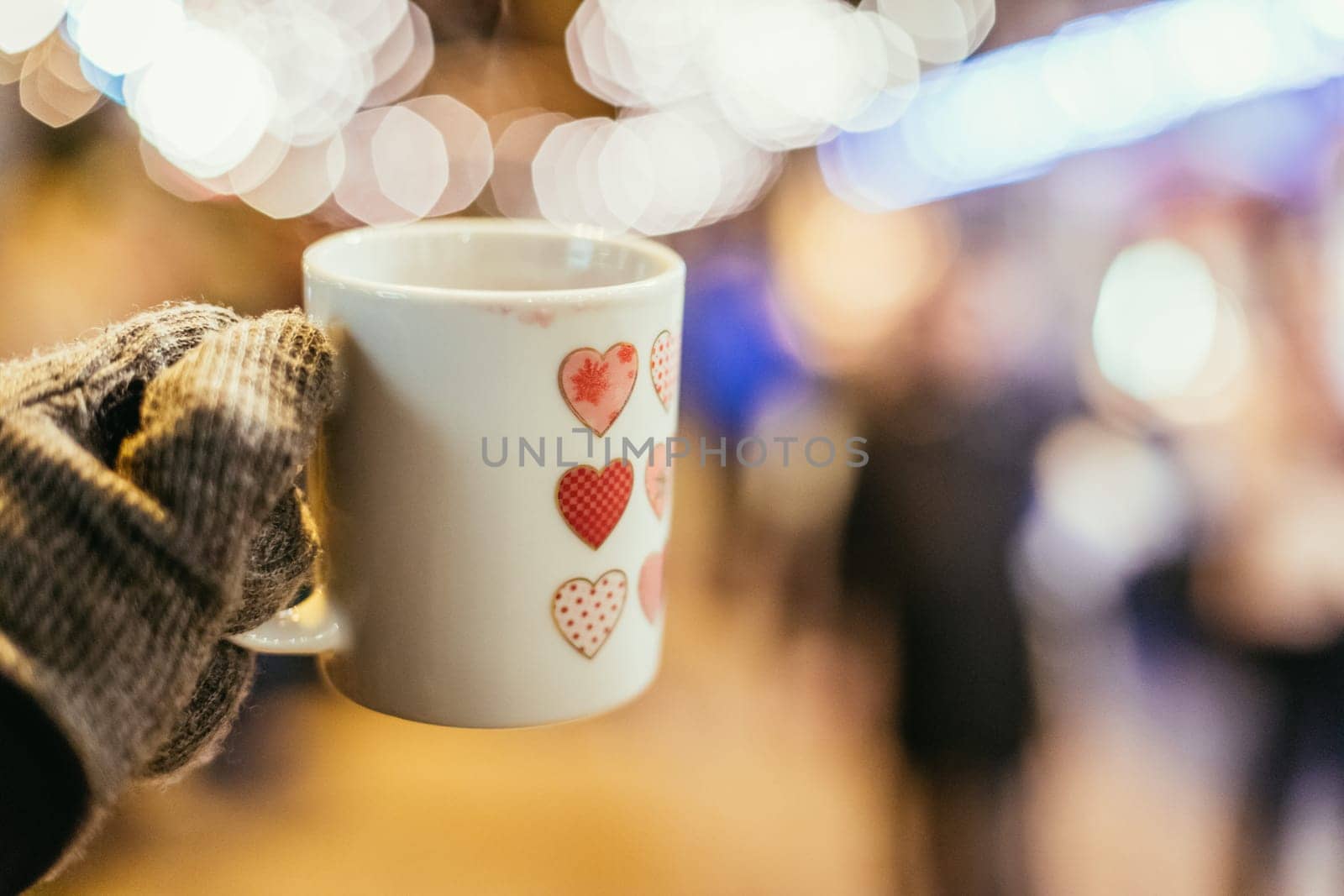 Enjoying Christmas time on the Christmas market. Close up of a cup of mulled wine.