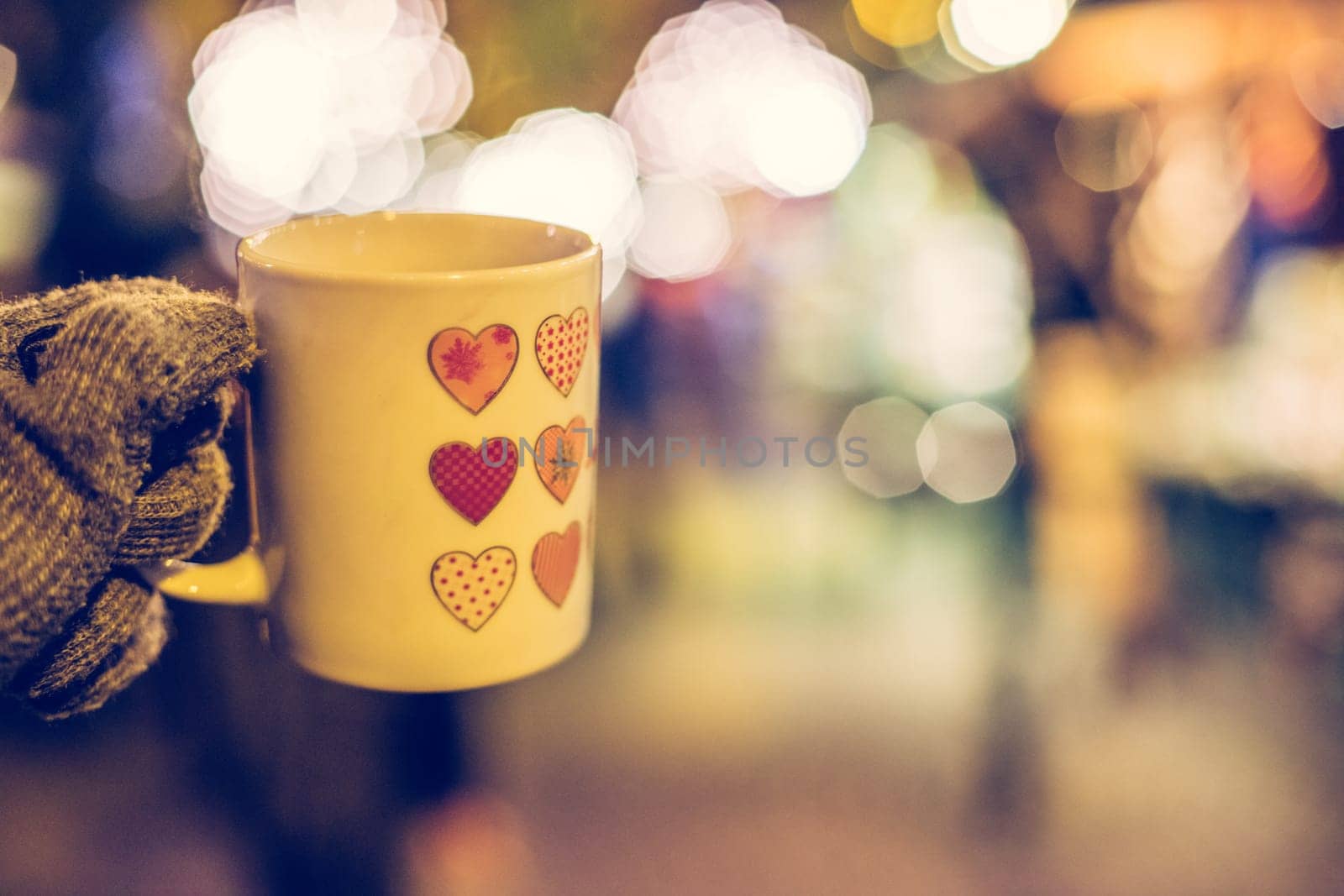 Enjoying Christmas time on the Christmas market. Close up of a cup of mulled wine.