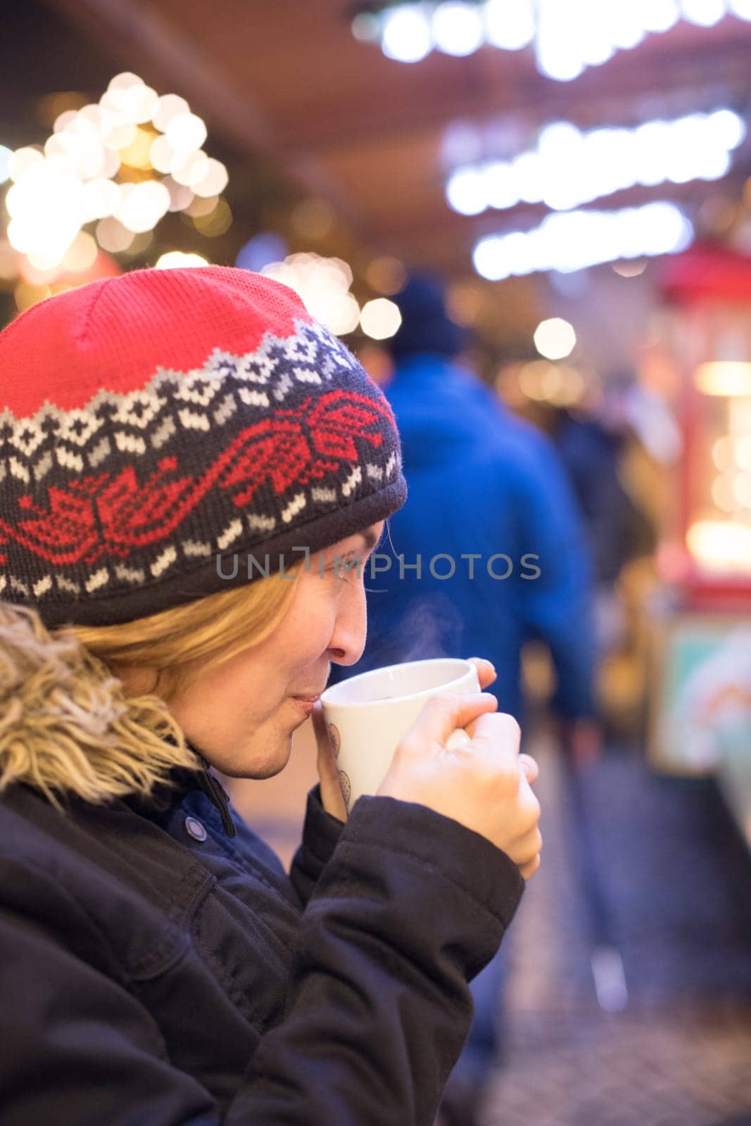 Girl is drinking mulled wine on the Christmas market, fun