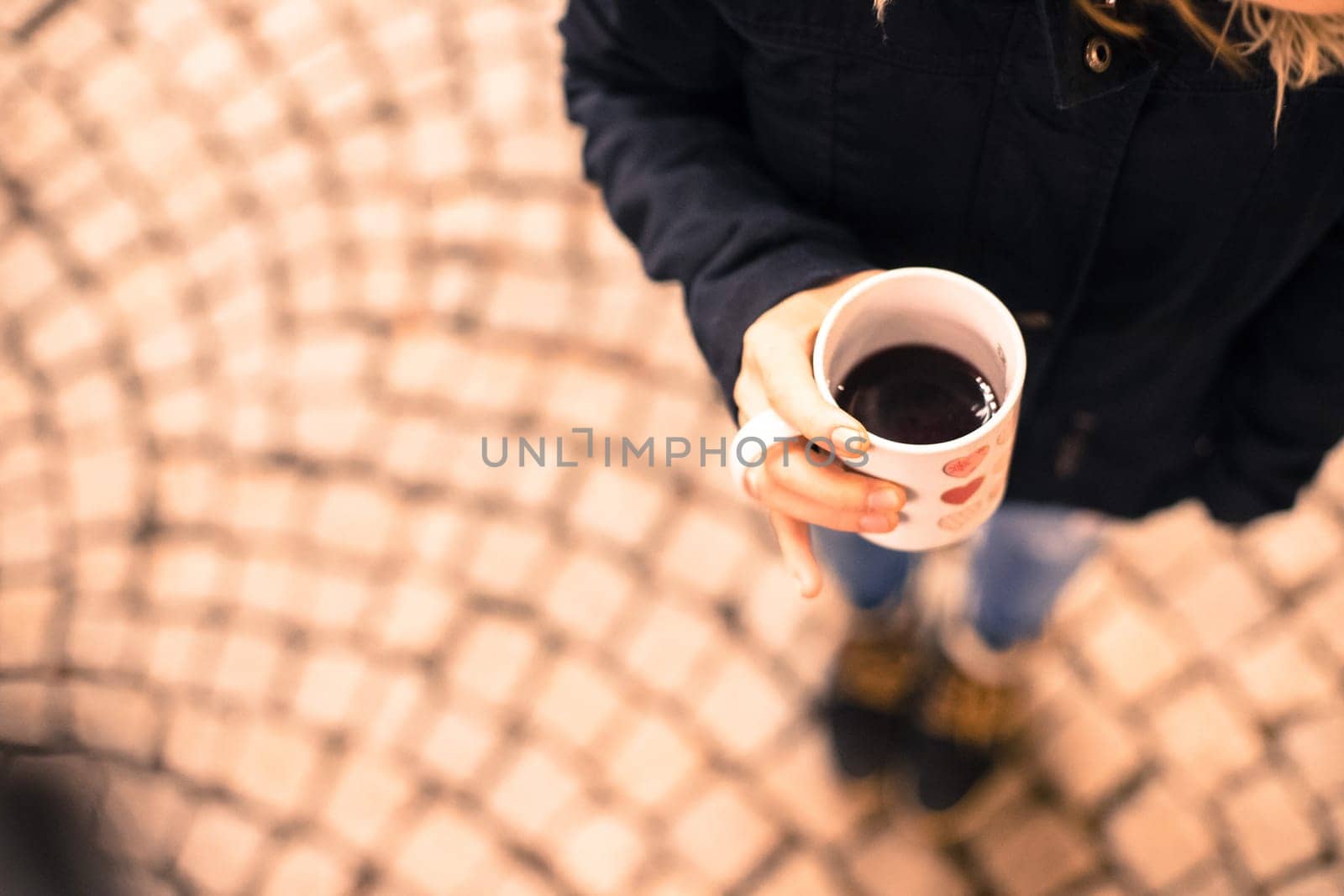 Enjoying Christmas time on the Christmas market. Close up of a cup of mulled wine.