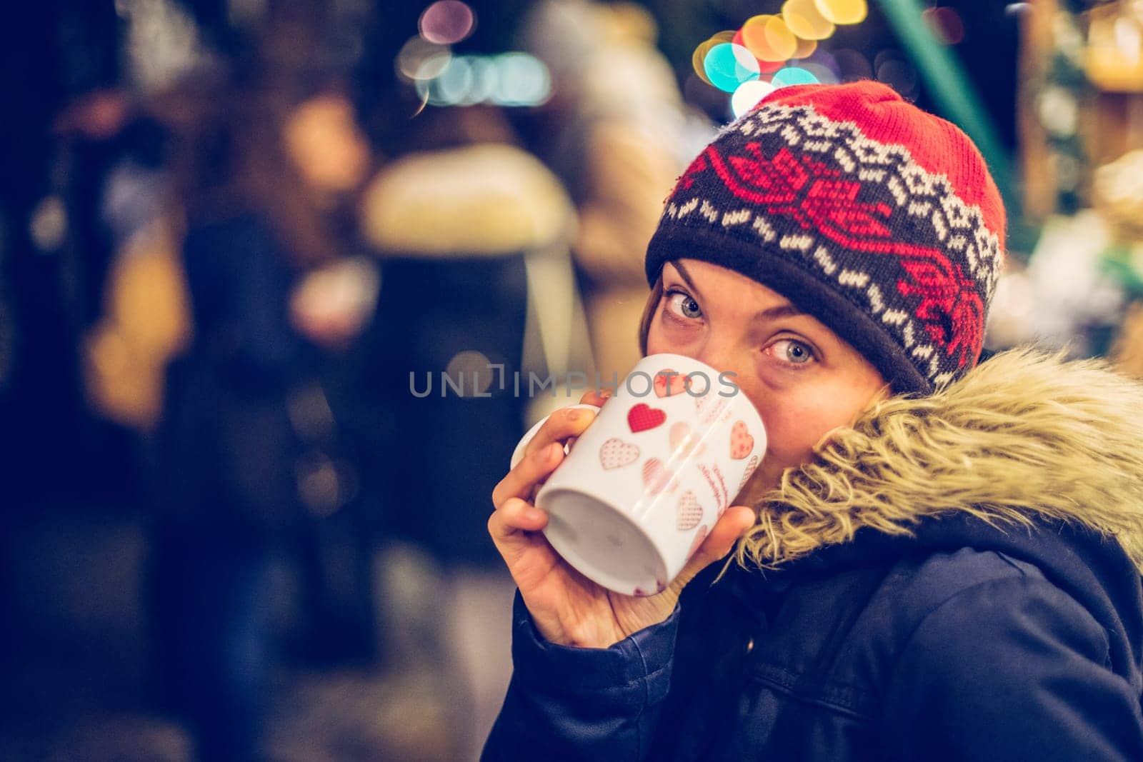 Girl is drinking mulled wine on the Christmas market, fun