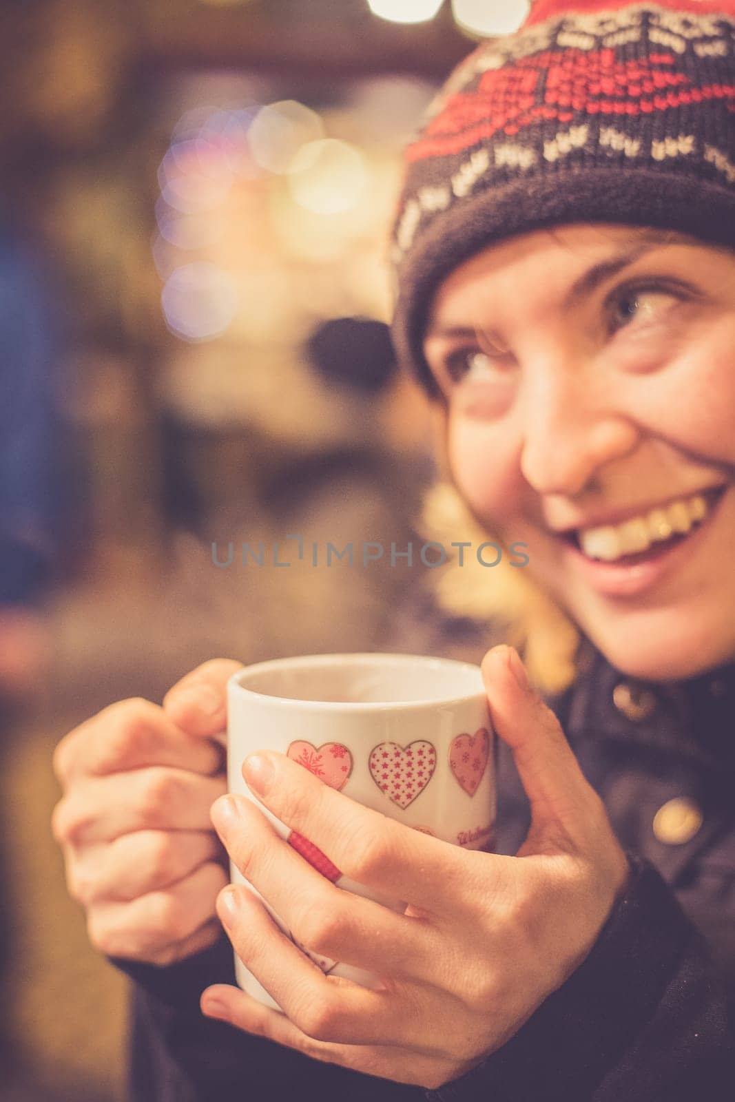Girl is drinking mulled wine on the Christmas market, fun