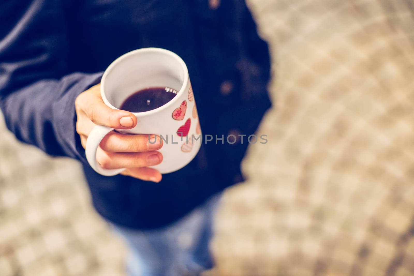 Enjoying Christmas time on the Christmas market. Close up of a cup of mulled wine.