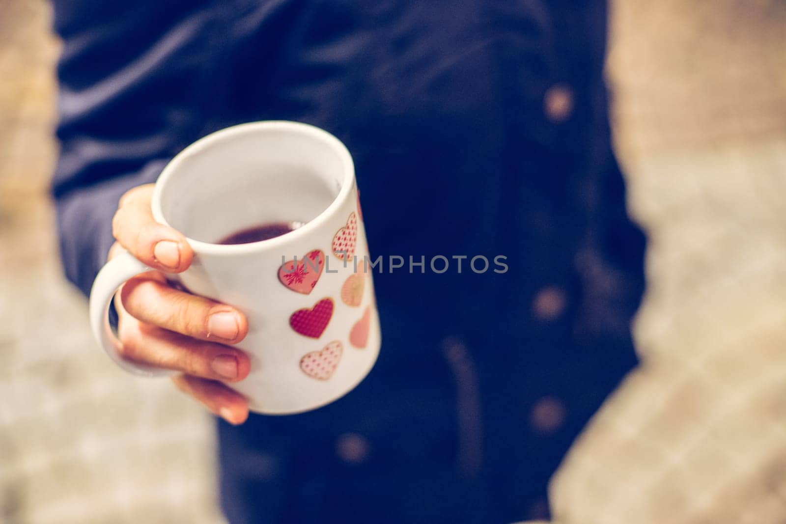 Enjoying Christmas time on the Christmas market. Close up of a cup of mulled wine.