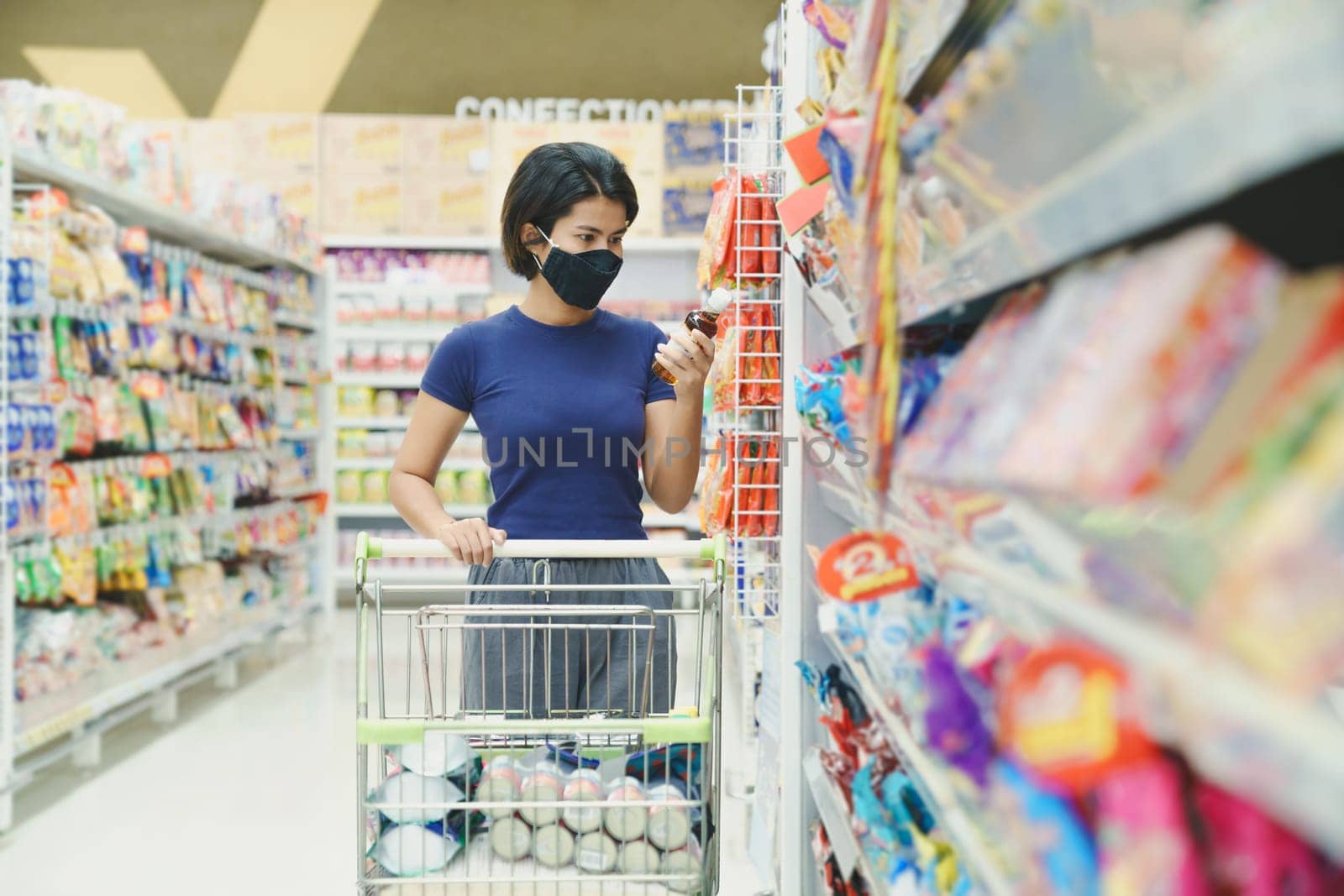 asia woman wearing mask shopping in mall department store