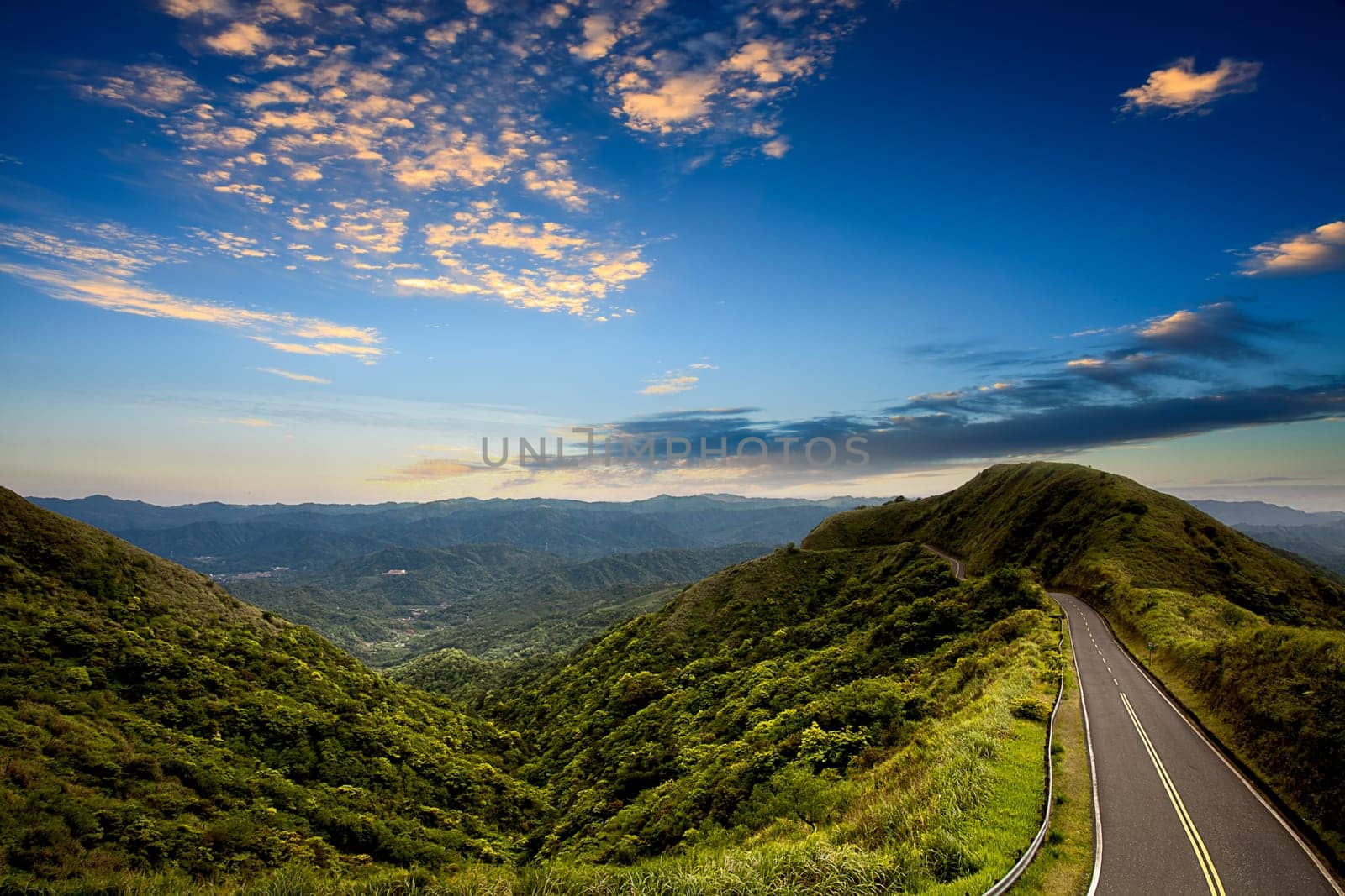The beautiful road and green mountain with nice lighting at sunset