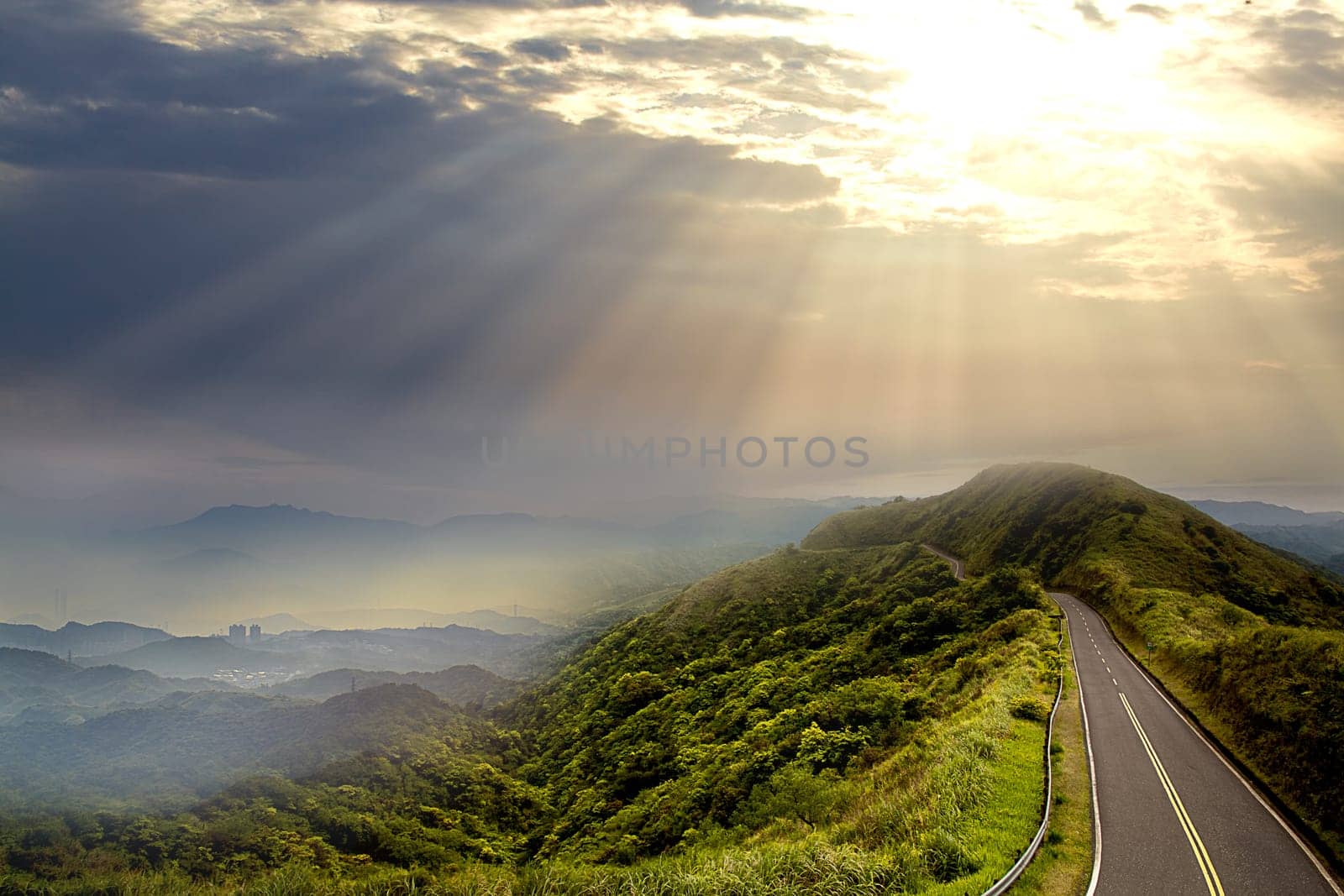 The beautiful road and green mountain with nice lighting at sunset