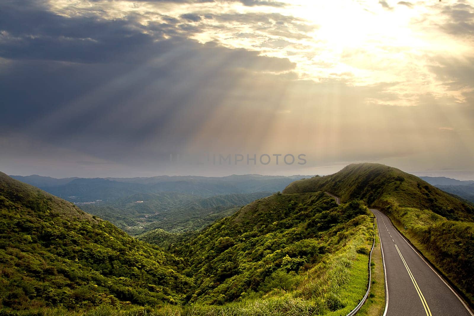 The beautiful road and green mountain with nice lighting at sunset