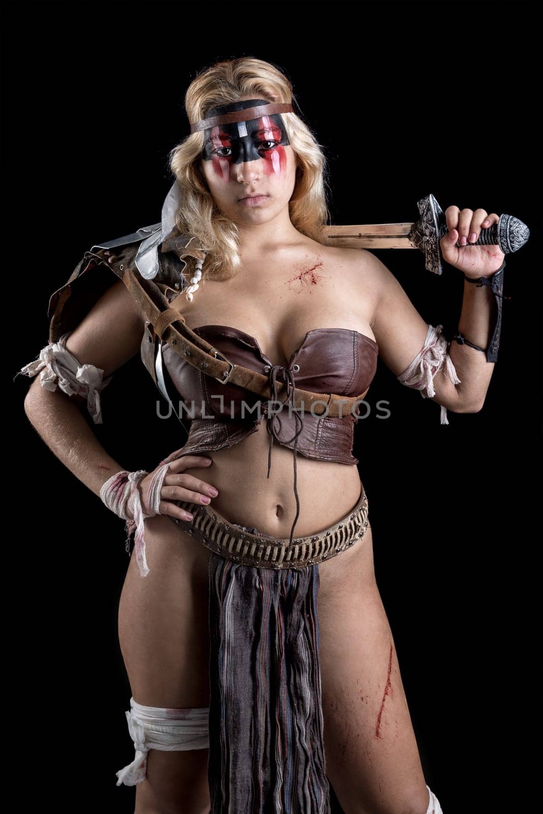 Ancient woman warrior or Gladiator posing in a dark background