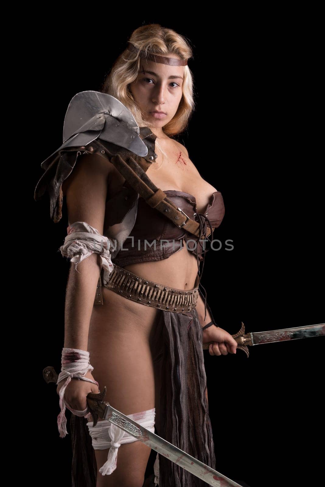 Ancient woman warrior or Gladiator posing in a dark background
