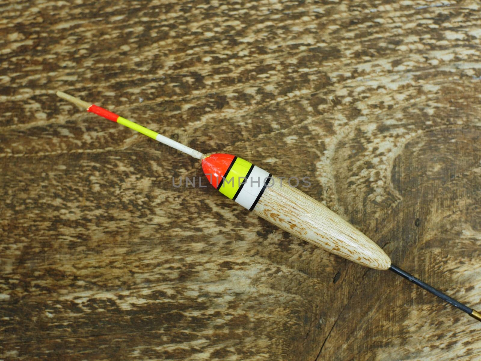 old wooden fishing float on weathered wood texture background