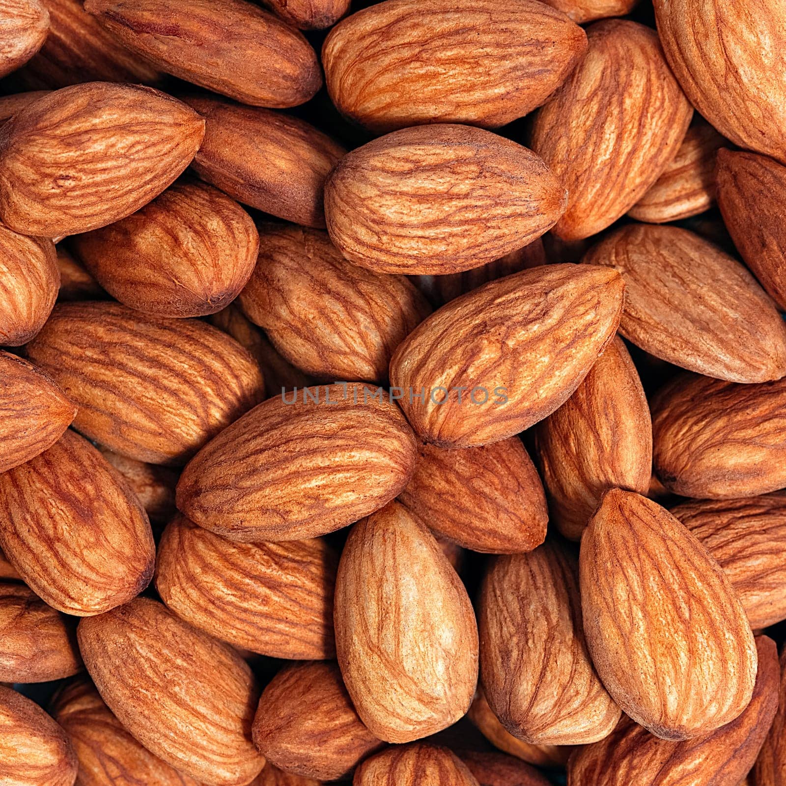 Background of almonds. Fried almonds. Scattered almond grains. Background for advertising, layout, mockup.