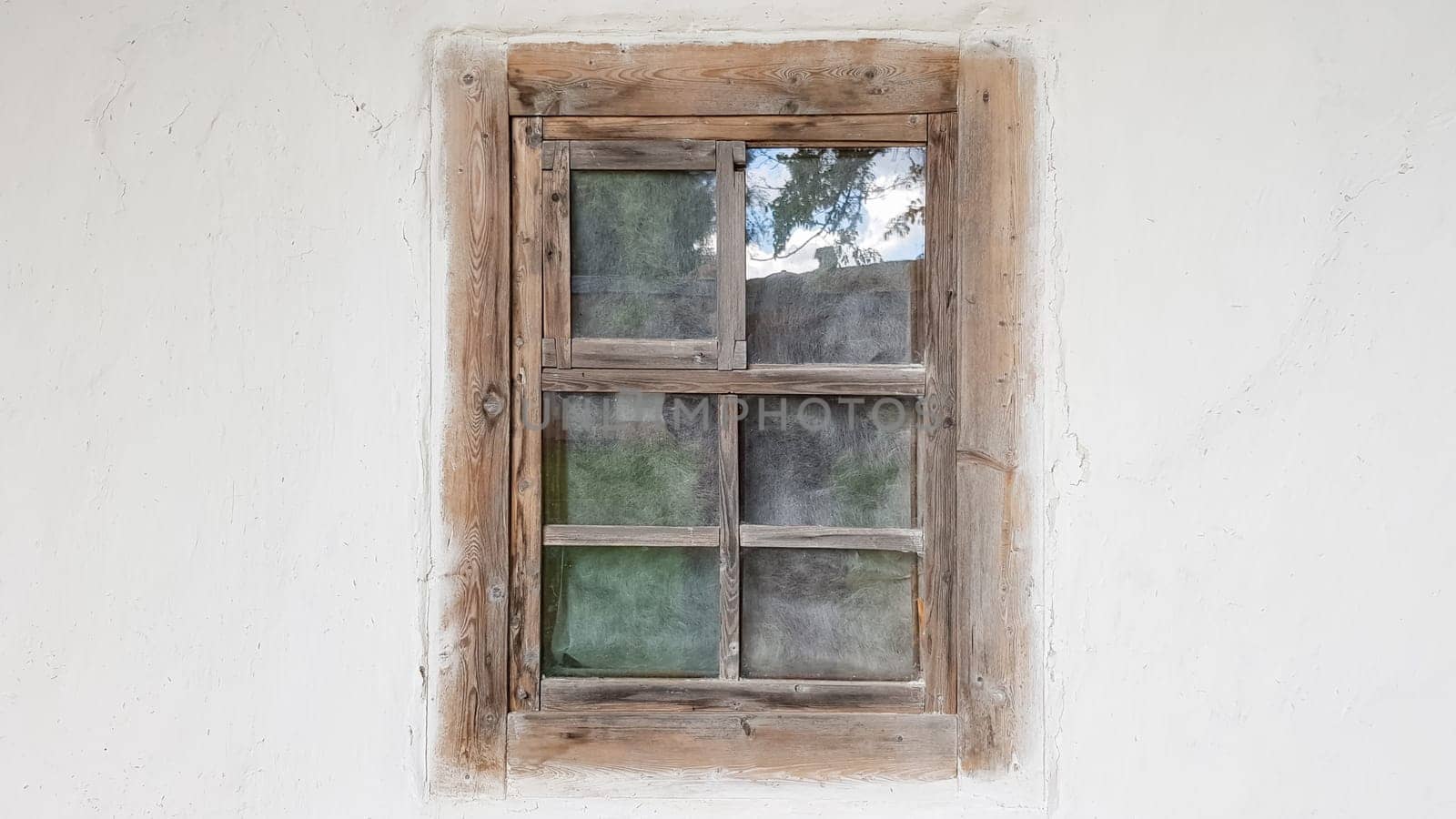 Ukraine, Kiev - June 11, 2020. Old window in a vintage traditional peasant house in Ukraine. Antique wooden window frame. Pirogovo National Museum in the open air in Kiev. Copy space