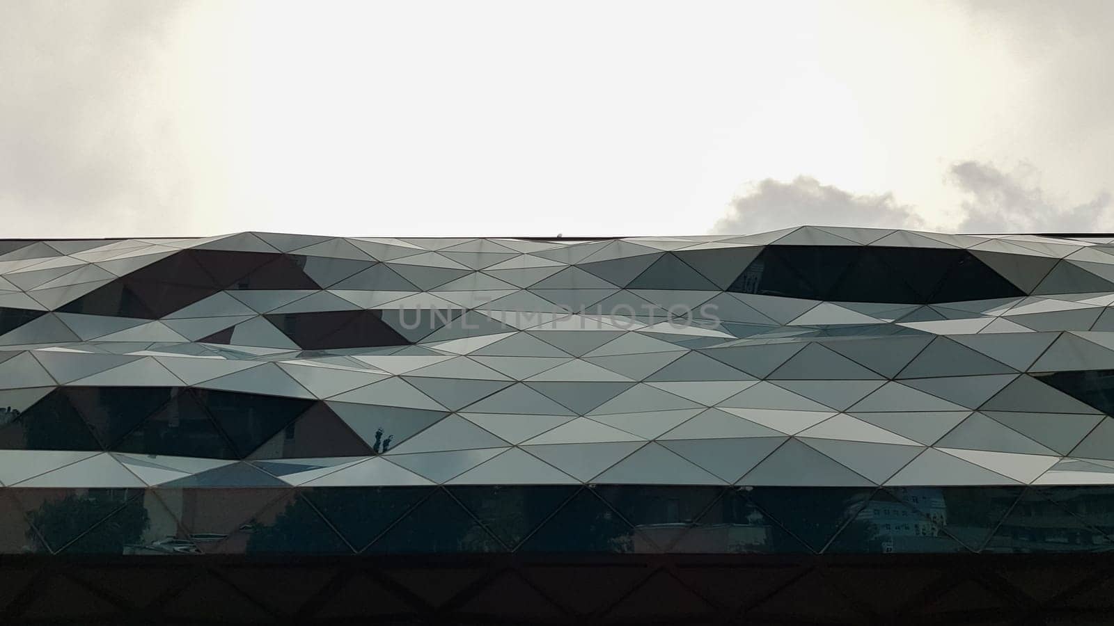 Ukraine, Kiev - June 1, 2020: facade of a curved glass building. modern architecture. Unusual design of the shopping center.