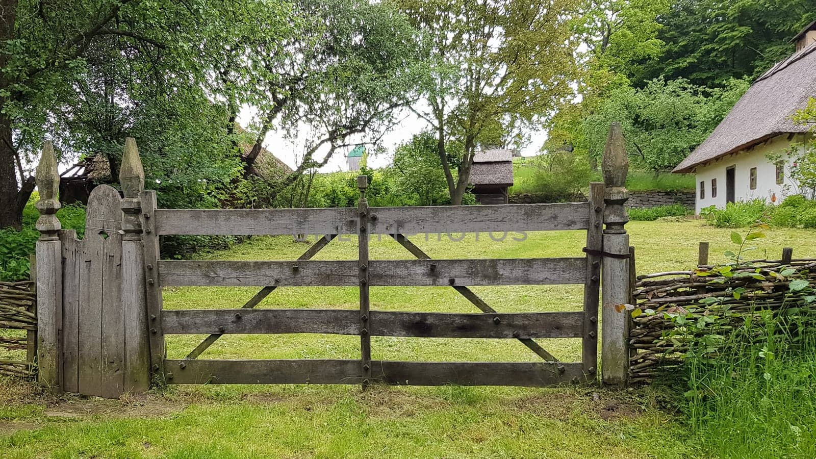 Closed wooden gate from the boards in the village or village. Vintage style design
