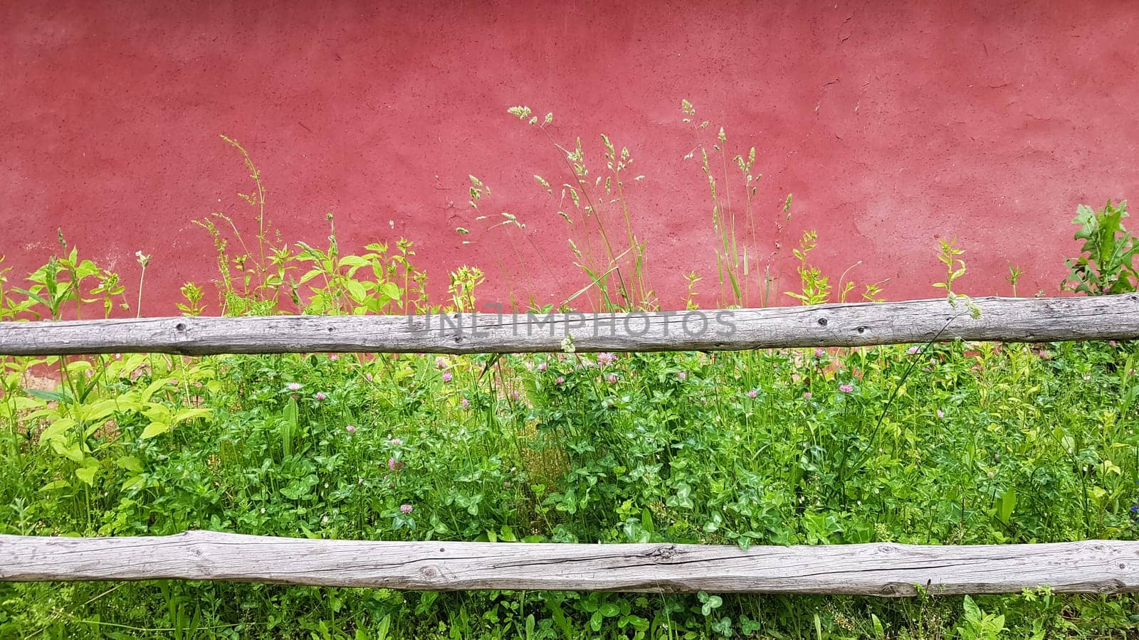 Texture of an old clay facade of a house painted in purple. Ukrainian old house