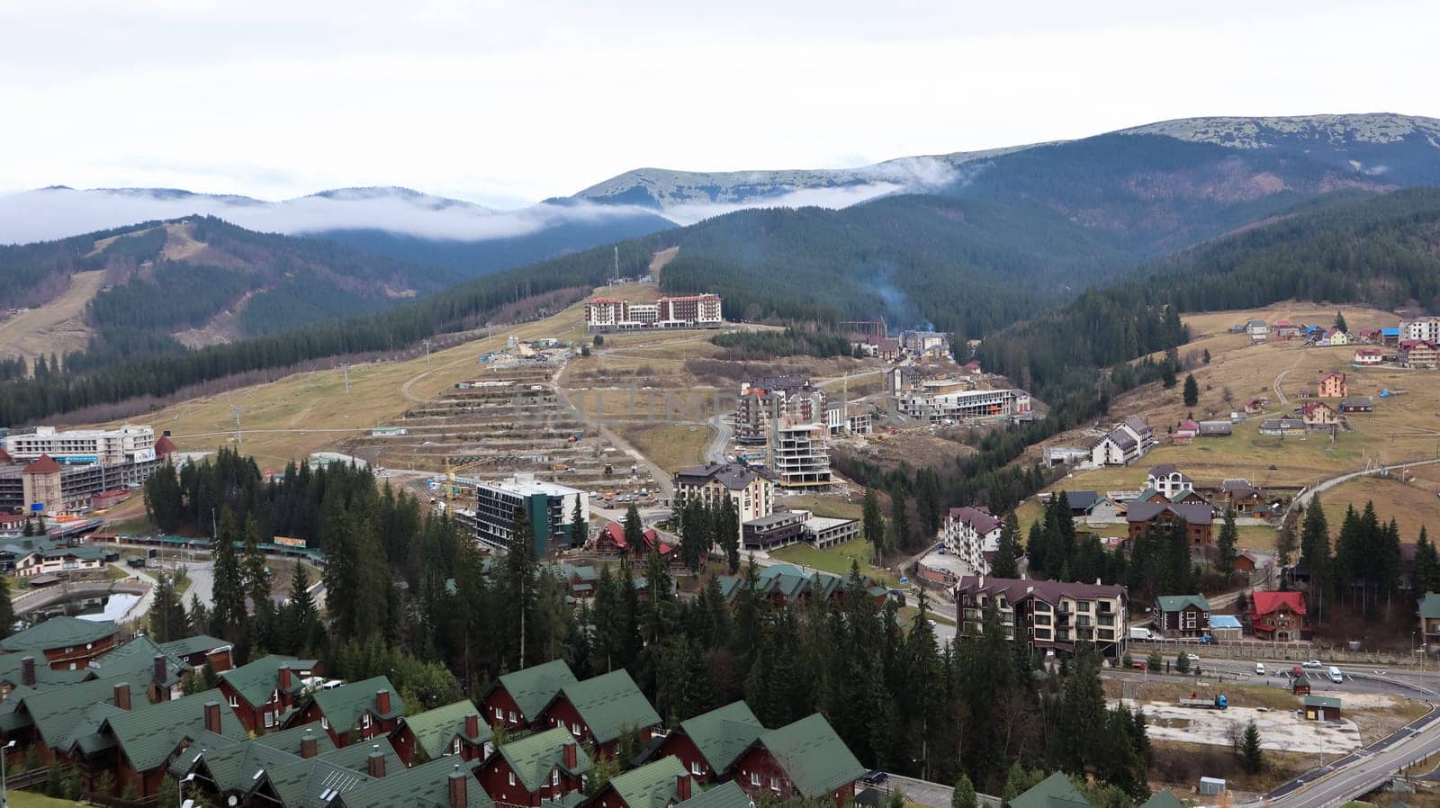 Bukovel ski resort in autumn aerial view. View of hotel houses in the ecological countryside against the background of spruce trees and mountain hills.Ukraine, Bukovel - November 20, 2019