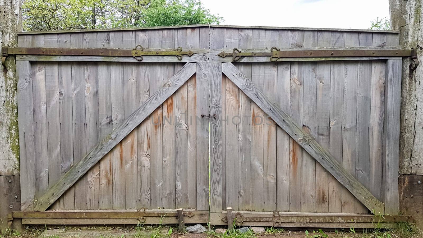 Closed wooden gate from the boards in the village or village. Vintage style design