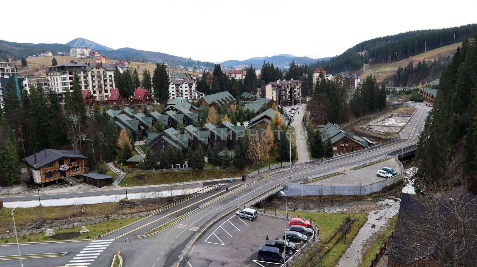 Bukovel ski resort in autumn aerial view. View of hotel houses in the ecological countryside against the background of spruce trees and mountain hills.Ukraine, Bukovel - November 20, 2019