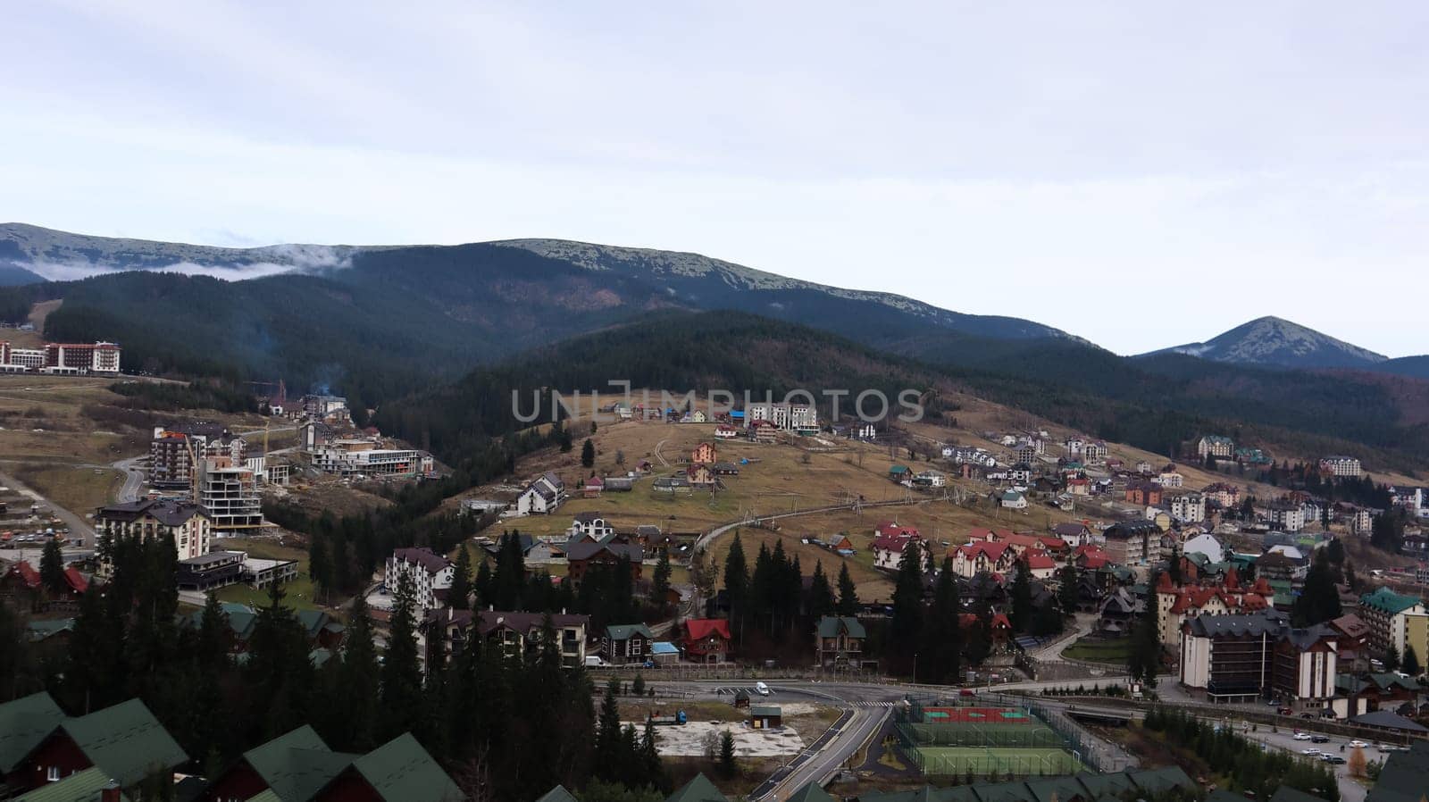 Bukovel ski resort in autumn aerial view. View of hotel houses in the ecological countryside against the background of spruce trees and mountain hills.Ukraine, Bukovel - November 20, 2019