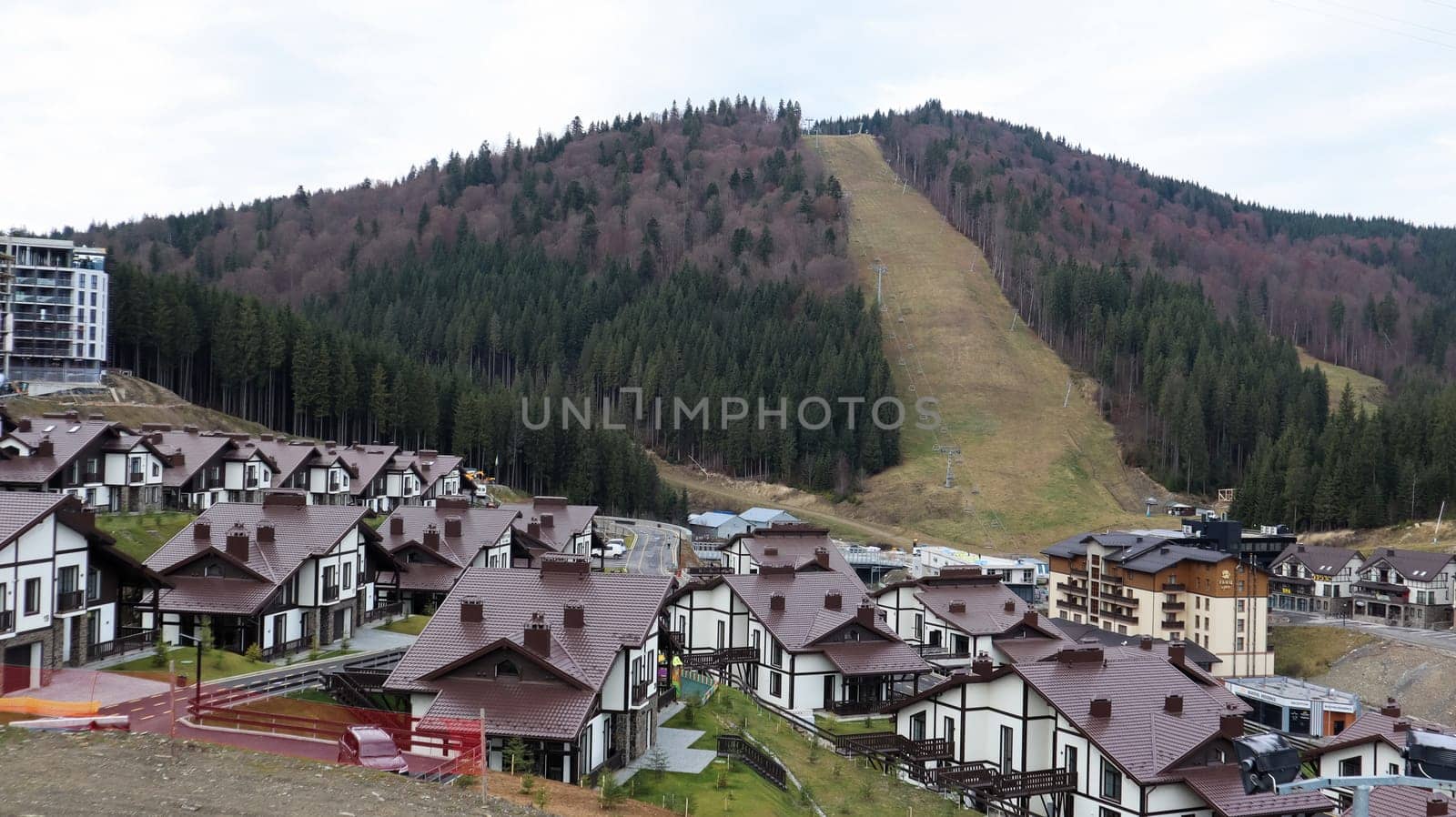 Bukovel ski resort in autumn aerial view. View of hotel houses in the ecological countryside against the background of spruce trees and mountain hills.Ukraine, Bukovel - November 20, 2019