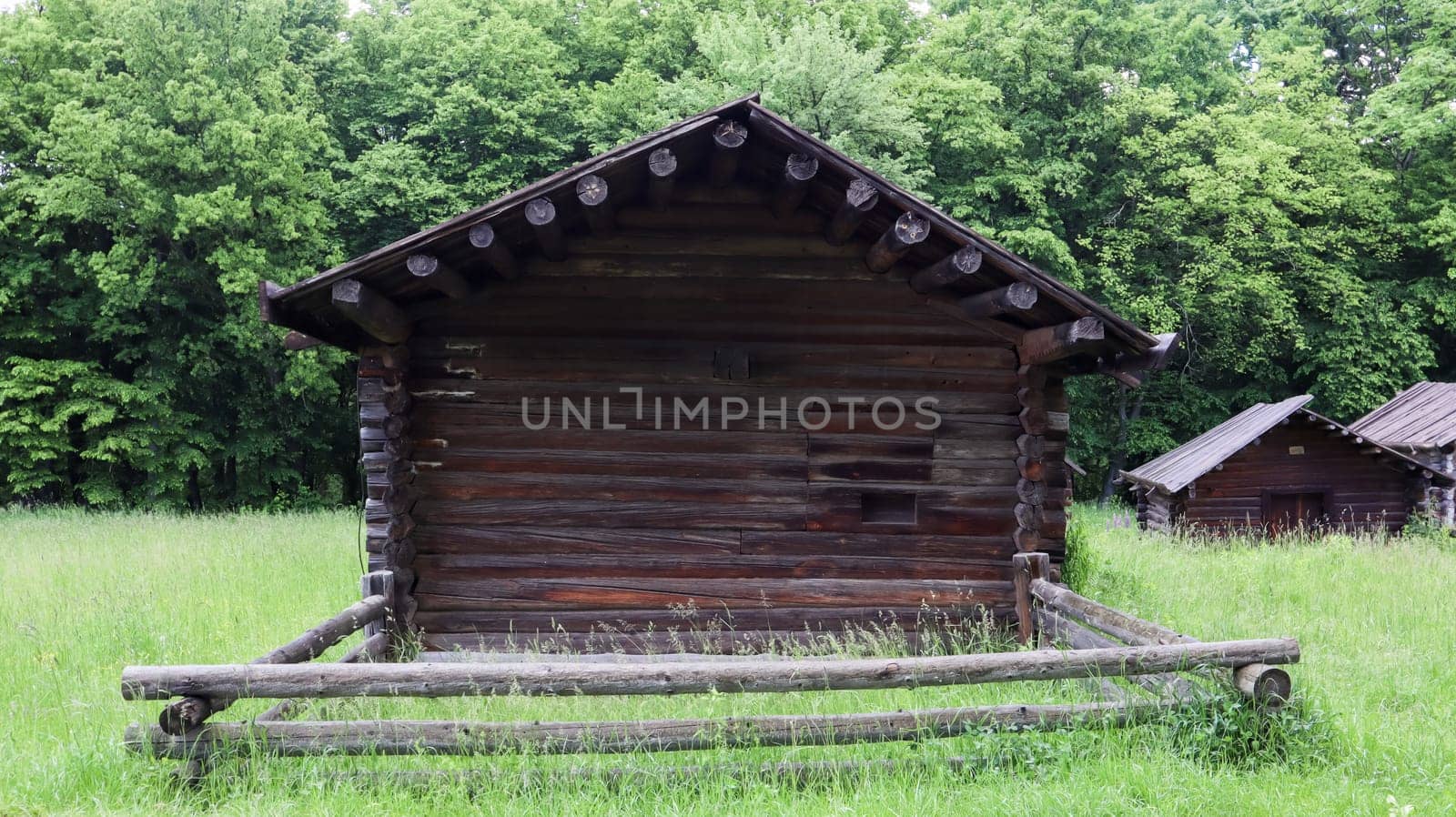 Ukraine, Kiev - June 11, 2020. Old peasant Ukrainian house or barn in the summer with a thatched roof in the village. Pirogovo Museum in the open air of different regions of Ukraine