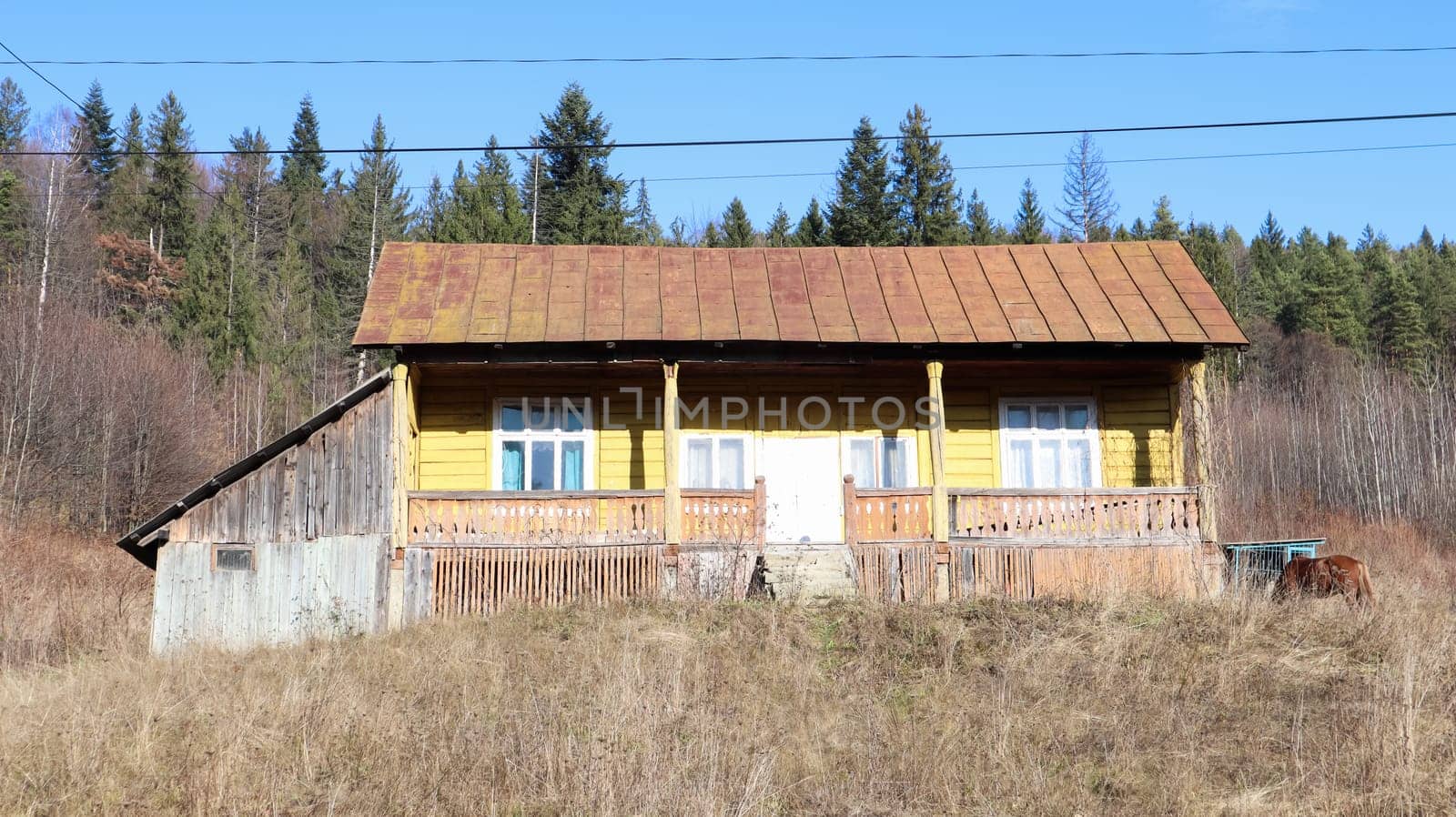 View of the picturesque village houses and cottages against the backdrop of mountains. The city of Yaremche among the Carpathians in the autumn afternoon. Ukraine, Yaremche - November 20, 2019.