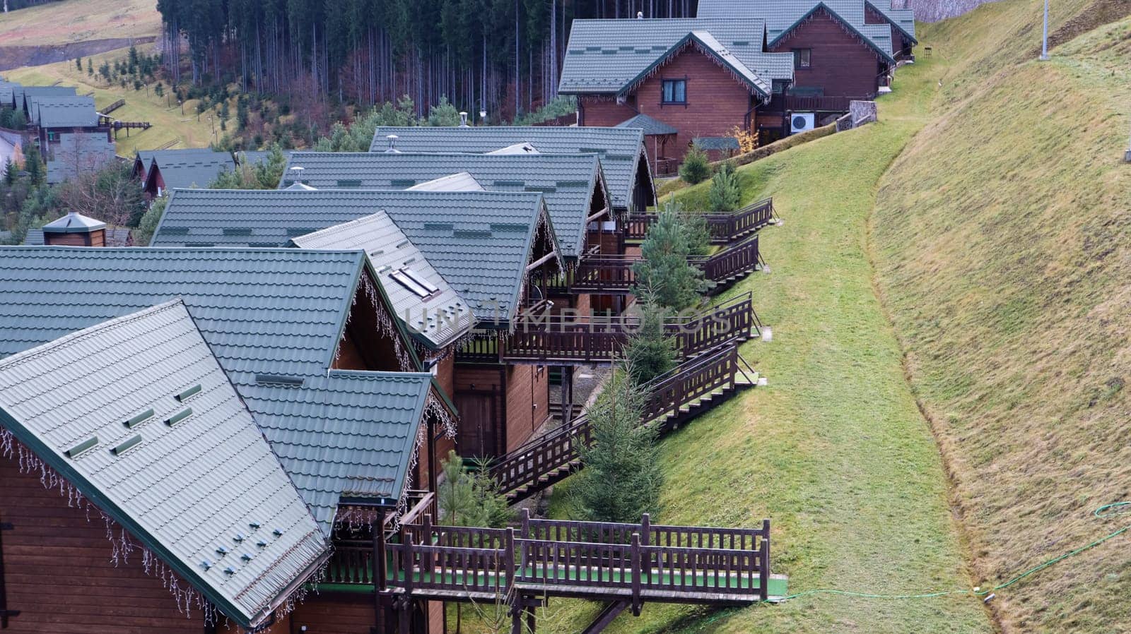 Bukovel ski resort in autumn aerial view. View of hotel houses in the ecological countryside against the background of spruce trees and mountain hills.Ukraine, Bukovel - November 20, 2019
