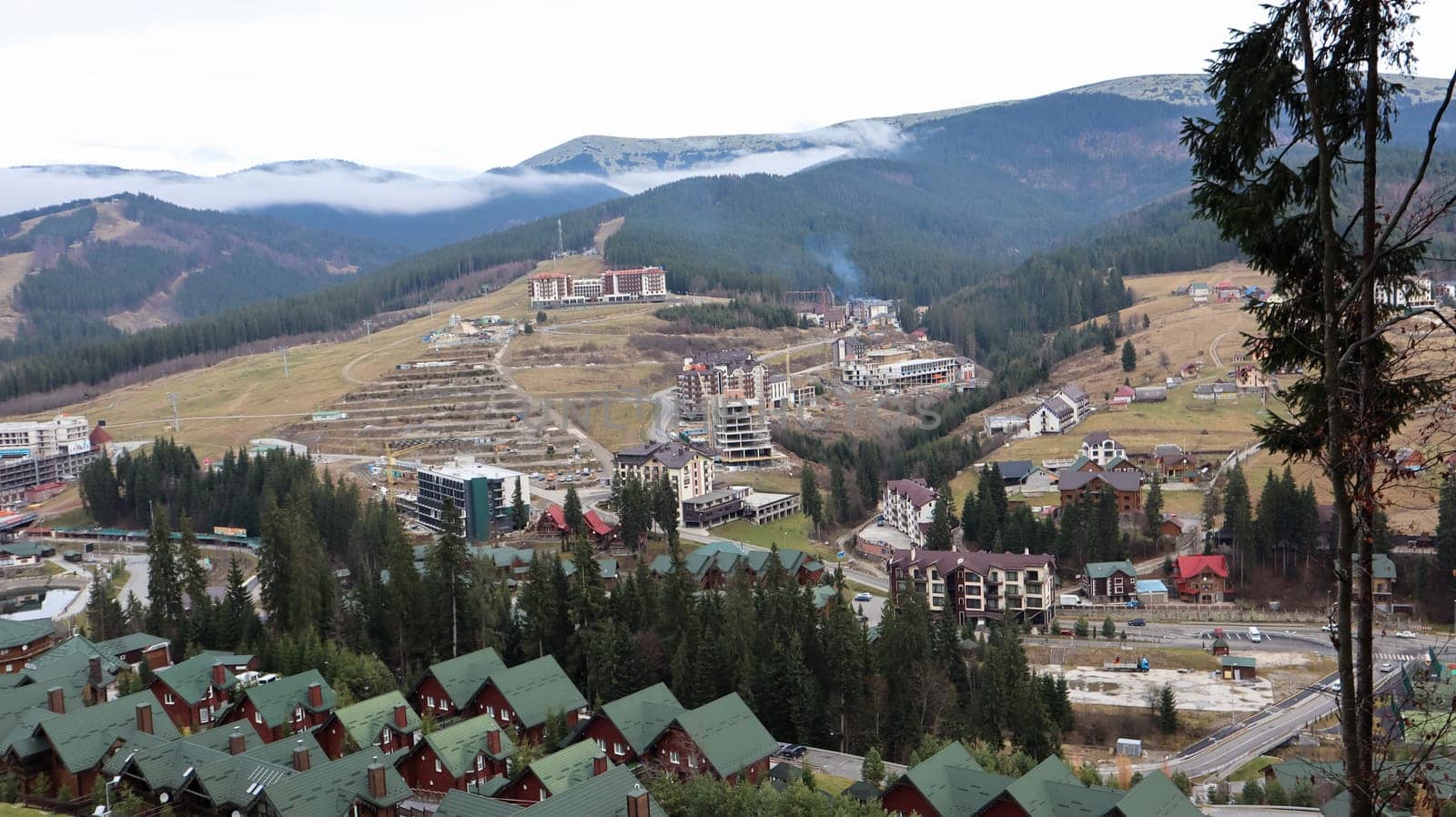 Bukovel ski resort in autumn aerial view. View of hotel houses in the ecological countryside against the background of spruce trees and mountain hills.Ukraine, Bukovel - November 20, 2019